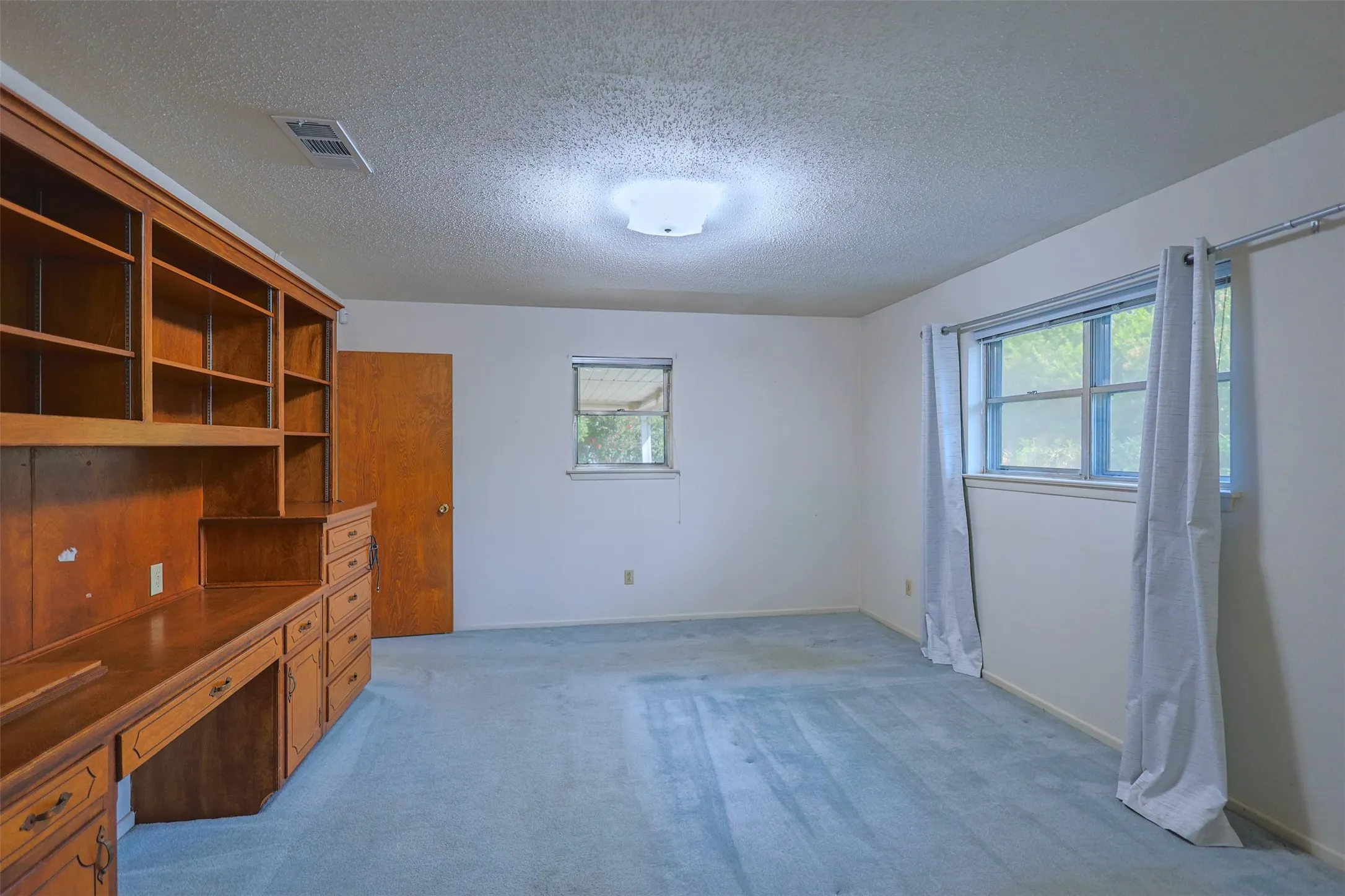 Room with light blue carpeting and white walls