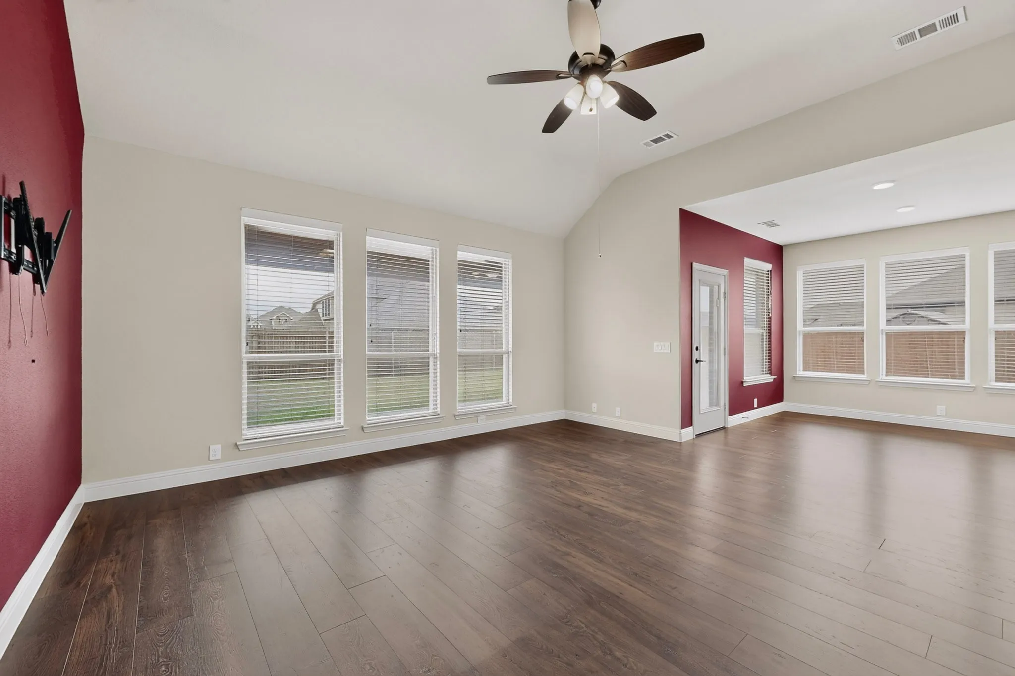 huge family room with wall of windows overlooking expansive backyard