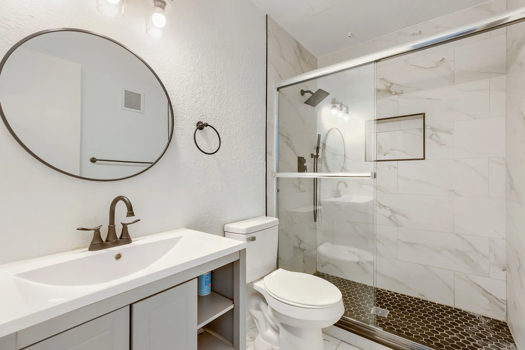 Full bathroom featuring a glass-enclosed shower