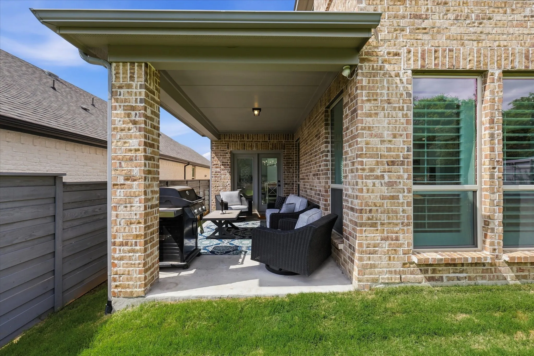 Covered patio featuring brick columns, recessed lighting, and a solid roof