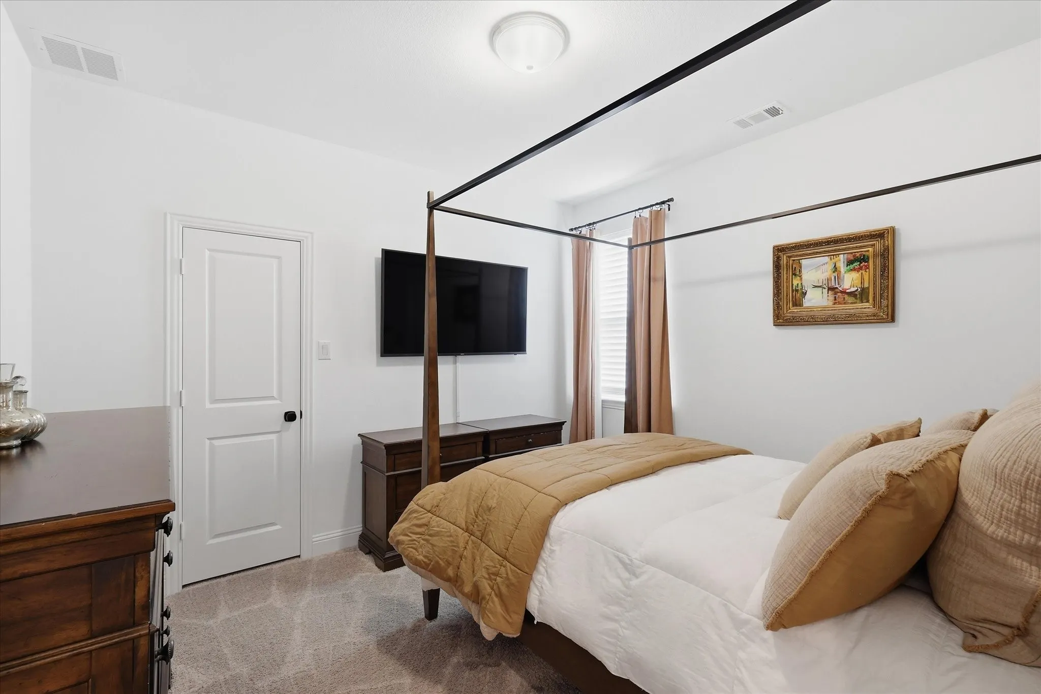 Neutral white walls featuring a single white panel door with black hardware, and a window with blinds and drapes