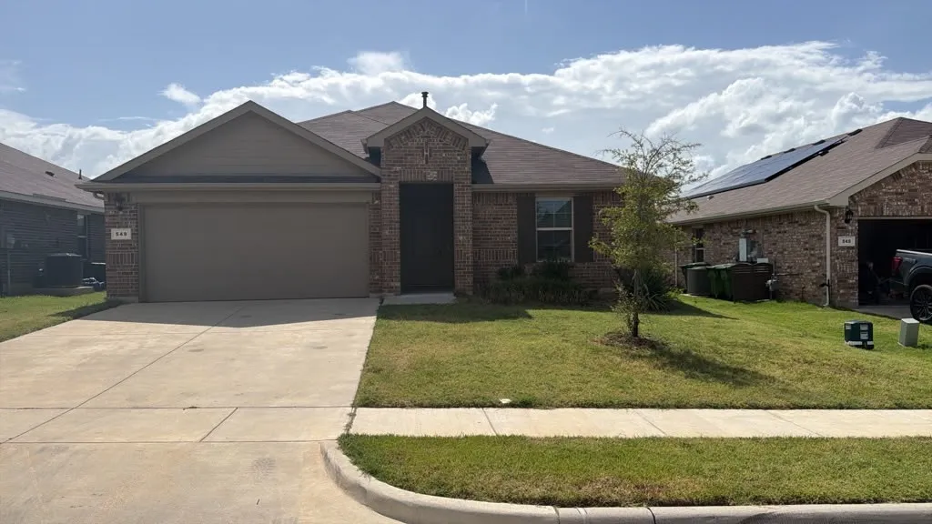 Brick veneer and siding exterior with a two-car garage and concrete driveway