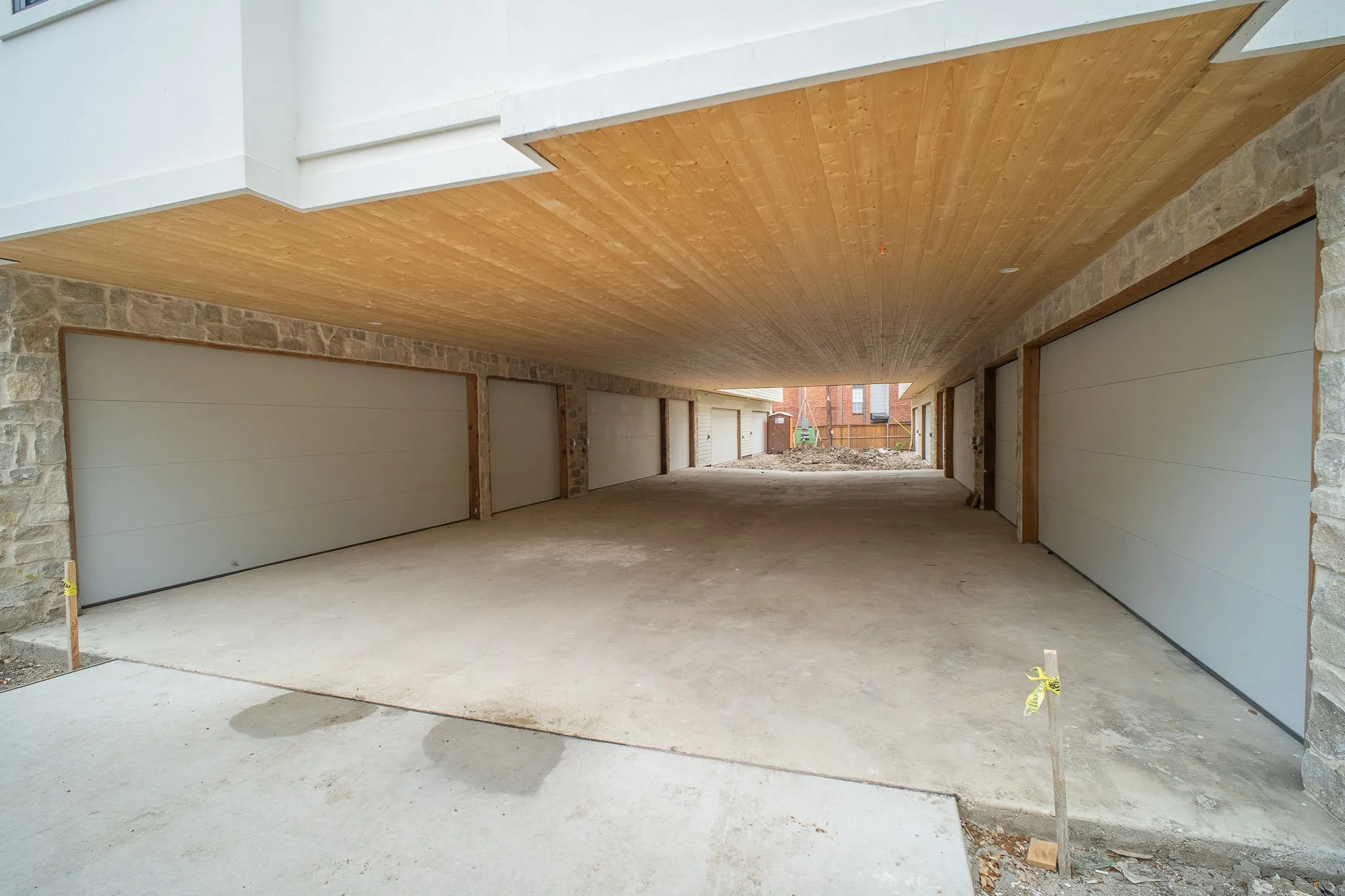 The property features a parking area with a concrete surface and a wood-paneled ceiling
