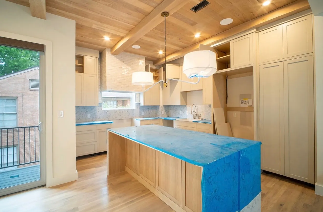 Kitchen featuring a wood plank ceiling with exposed beams, recessed lighting, and a large central island