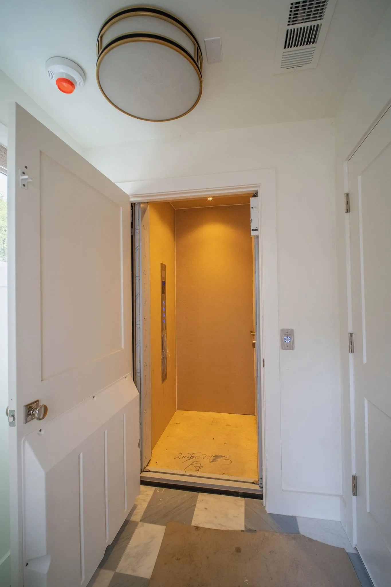 The property features a built-in elevator, accessible through a panel door