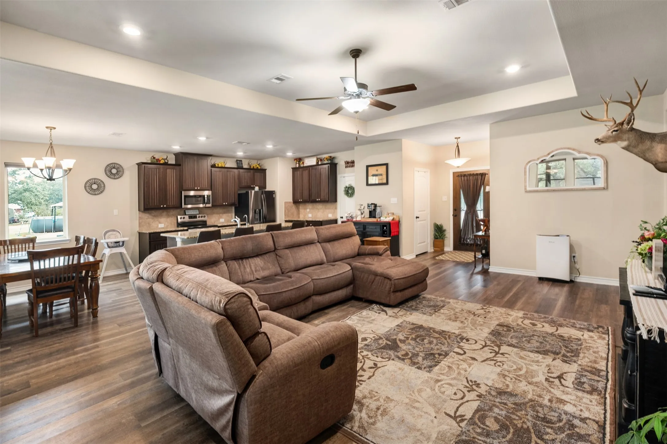 Open-concept living area featuring wood-finish flooring and recessed lighting
