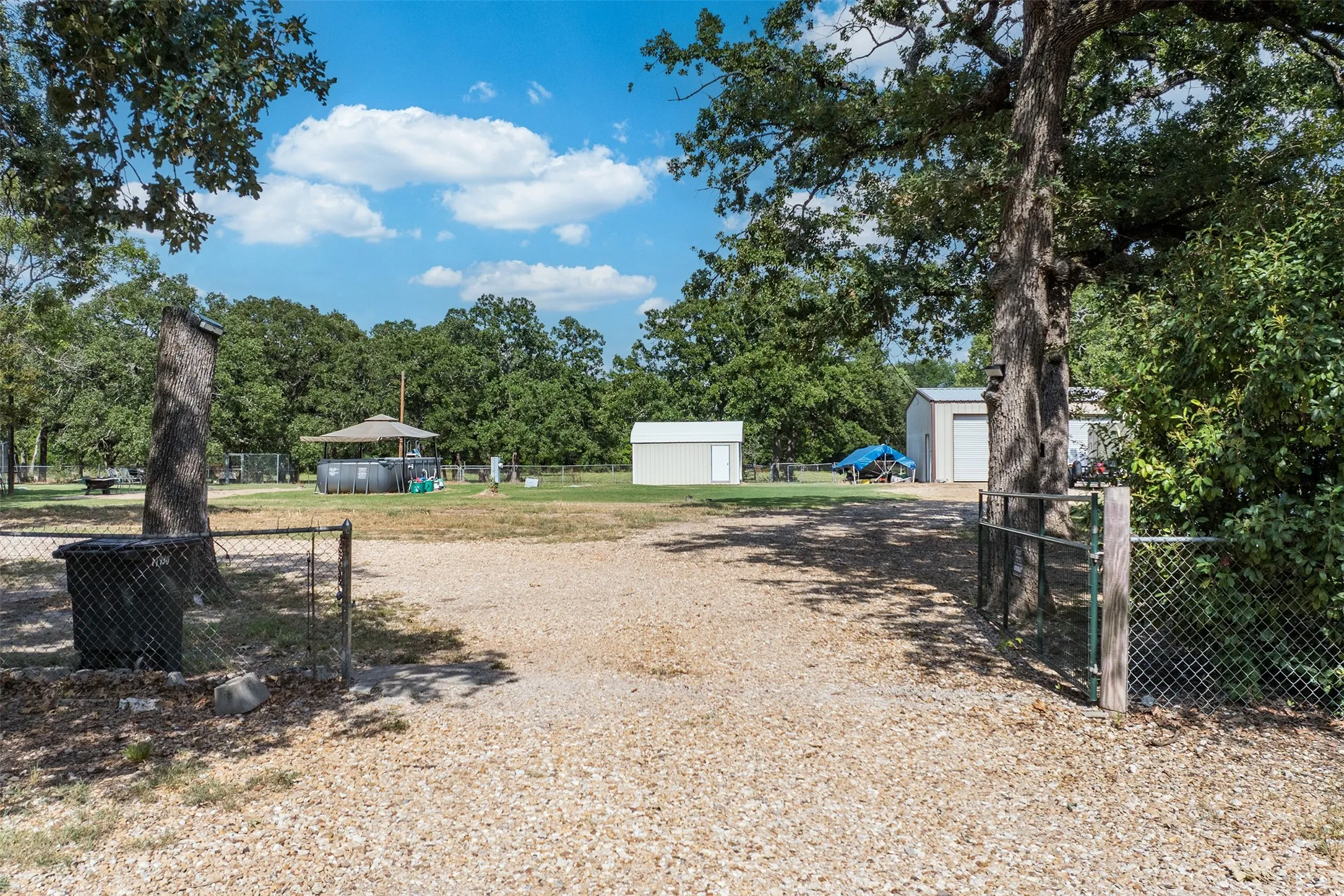 Entry, yard with chain link fence and gate.