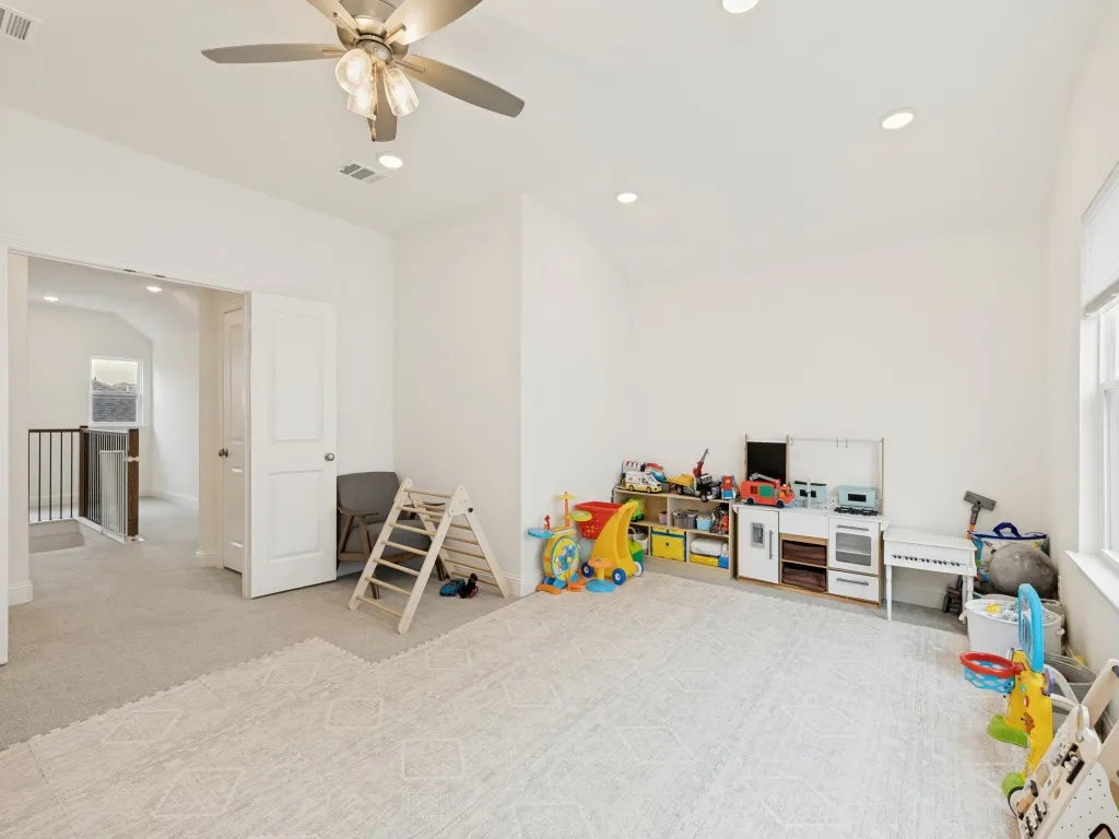 Spacious room with plush carpet flooring, recessed lighting, and a ceiling fan