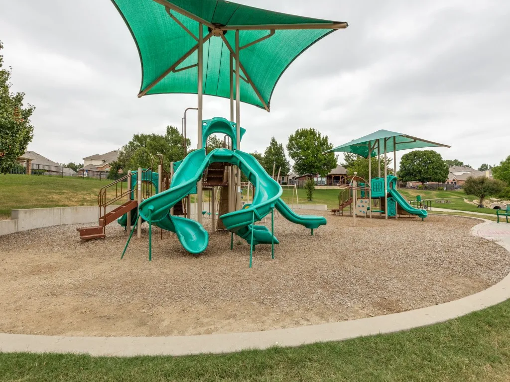 Community playground featuring multiple slides and climbing structures