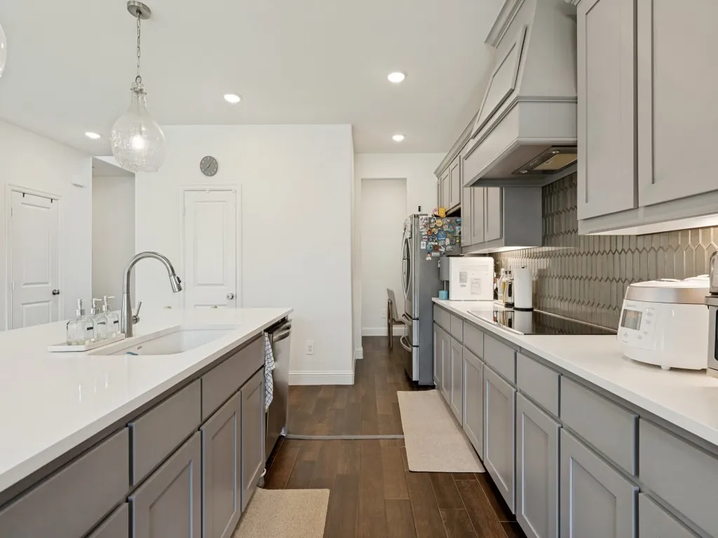 Contemporary kitchen featuring light gray cabinetry and white countertops