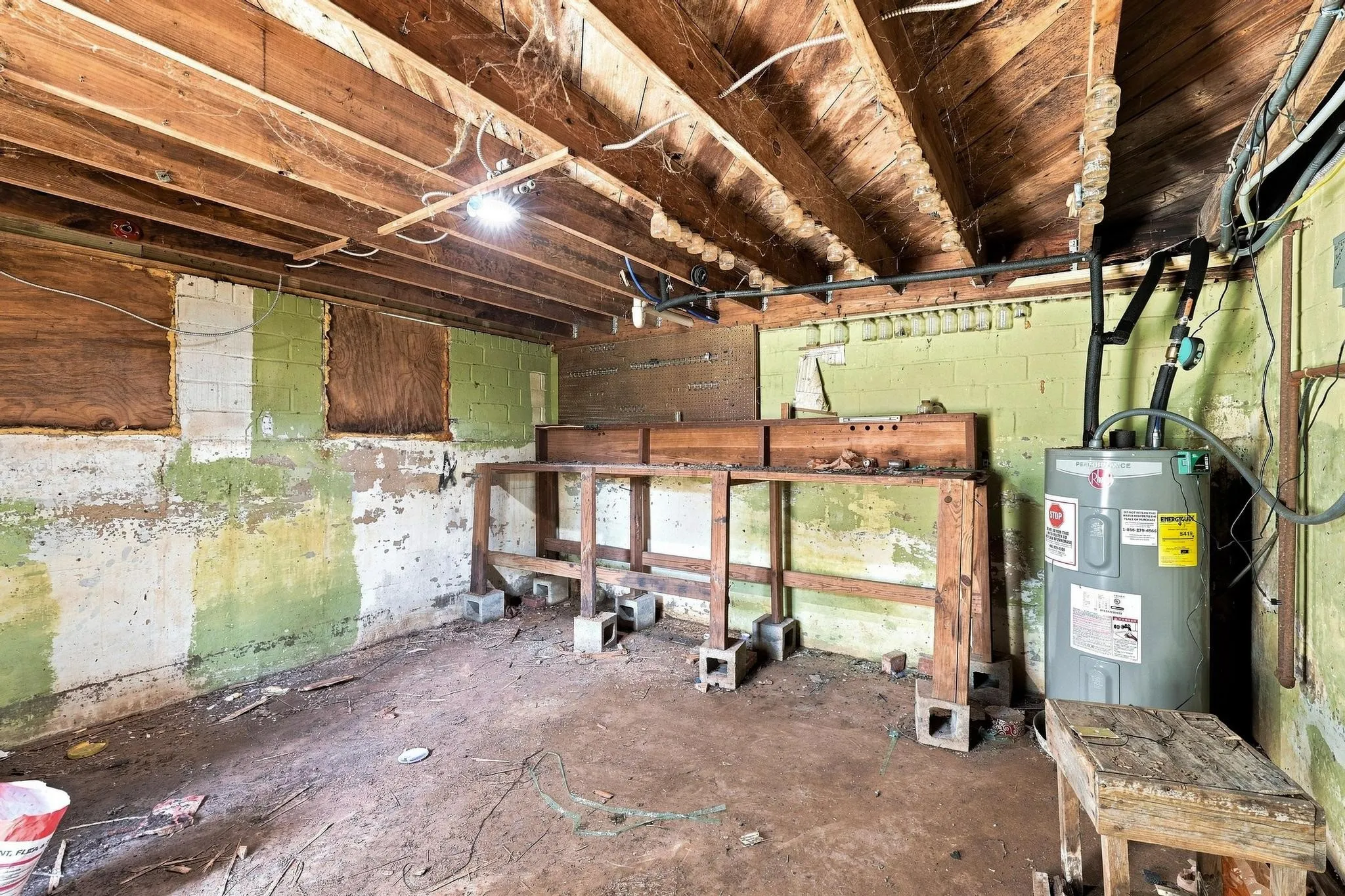 Cellar space providing room for workshop, storage and below ground safety shelter.