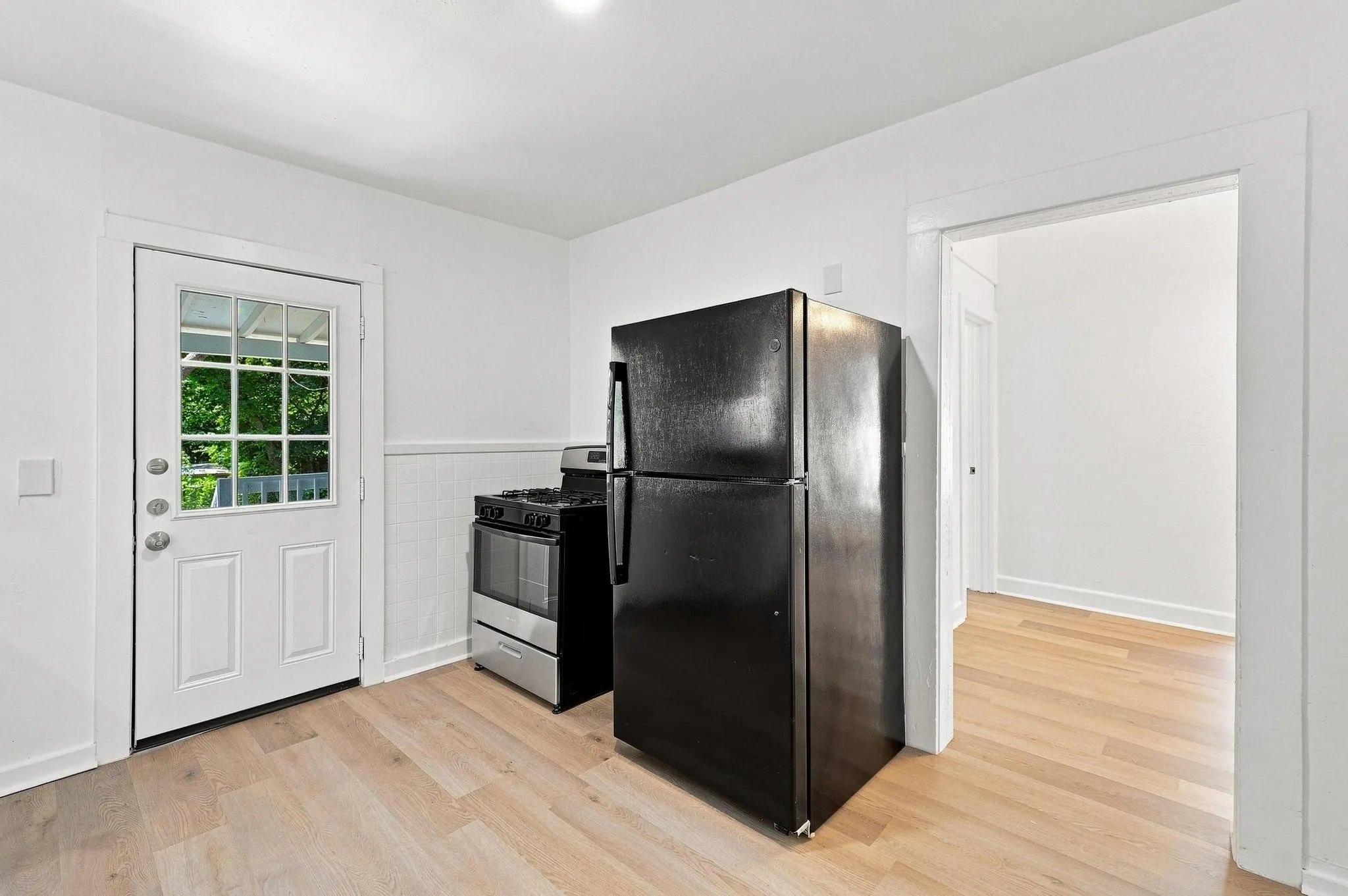Kitchen area with light wood-finish flooring