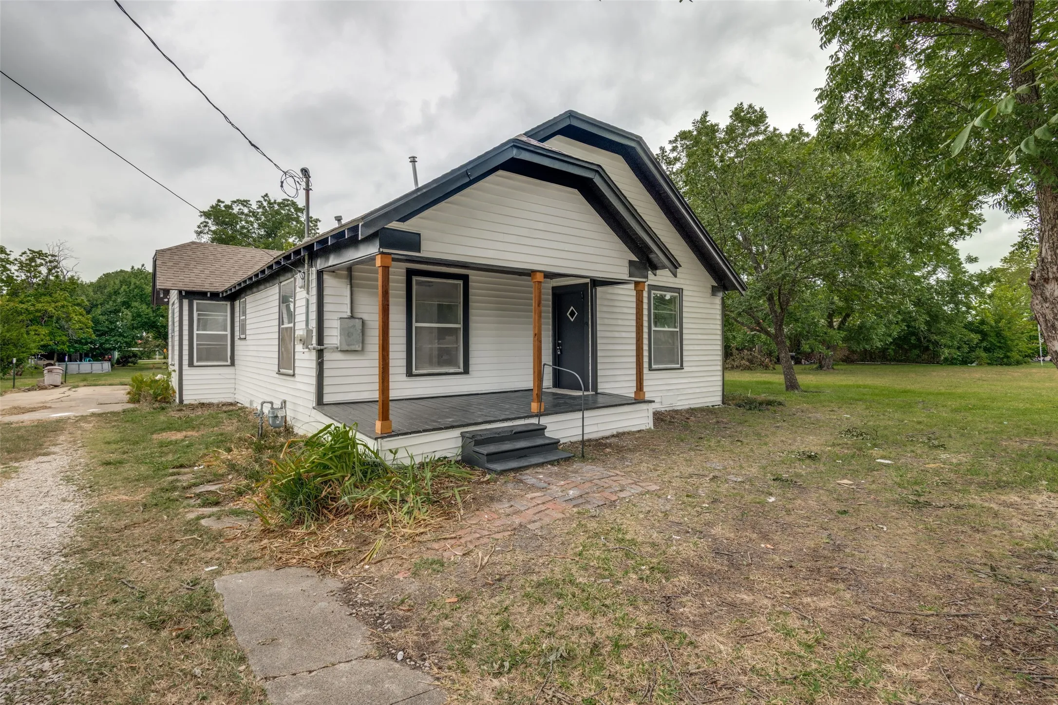 White siding exterior with a dark trim roofline