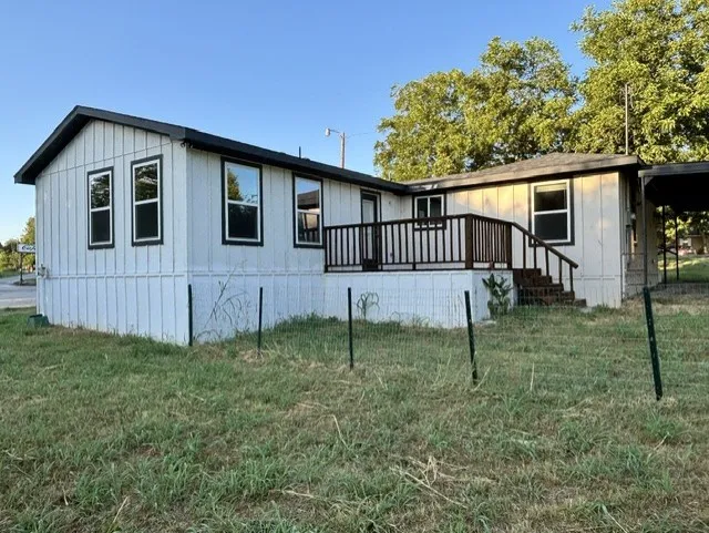 Spacious wood deck in back is ideal for relaxing at the end of the day.