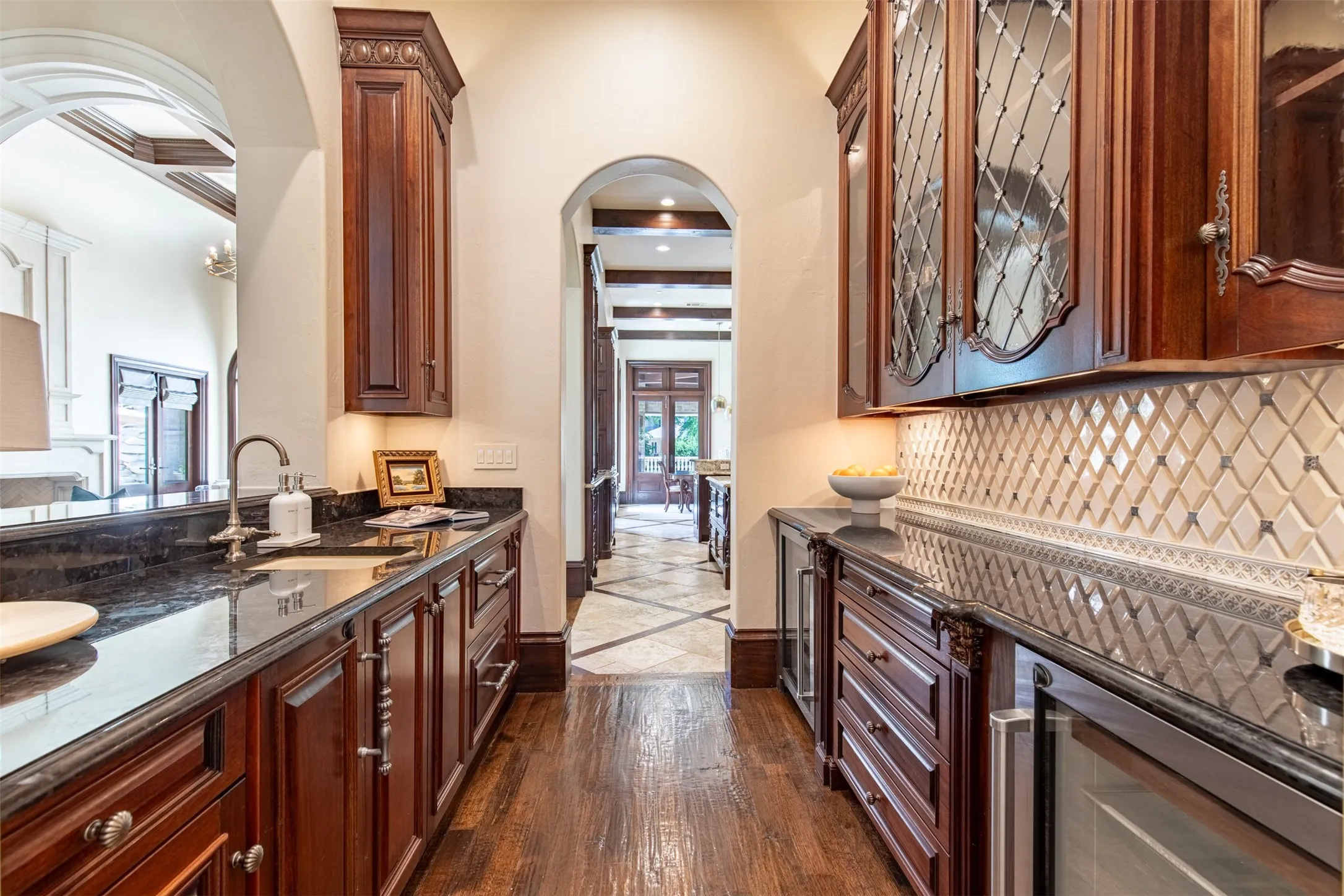 Butler's Pantry leading from dining room to kitchen. Includes a wine and beverage fridges, ice maker, two Sub-Zero drawer fridges, and bar sink.