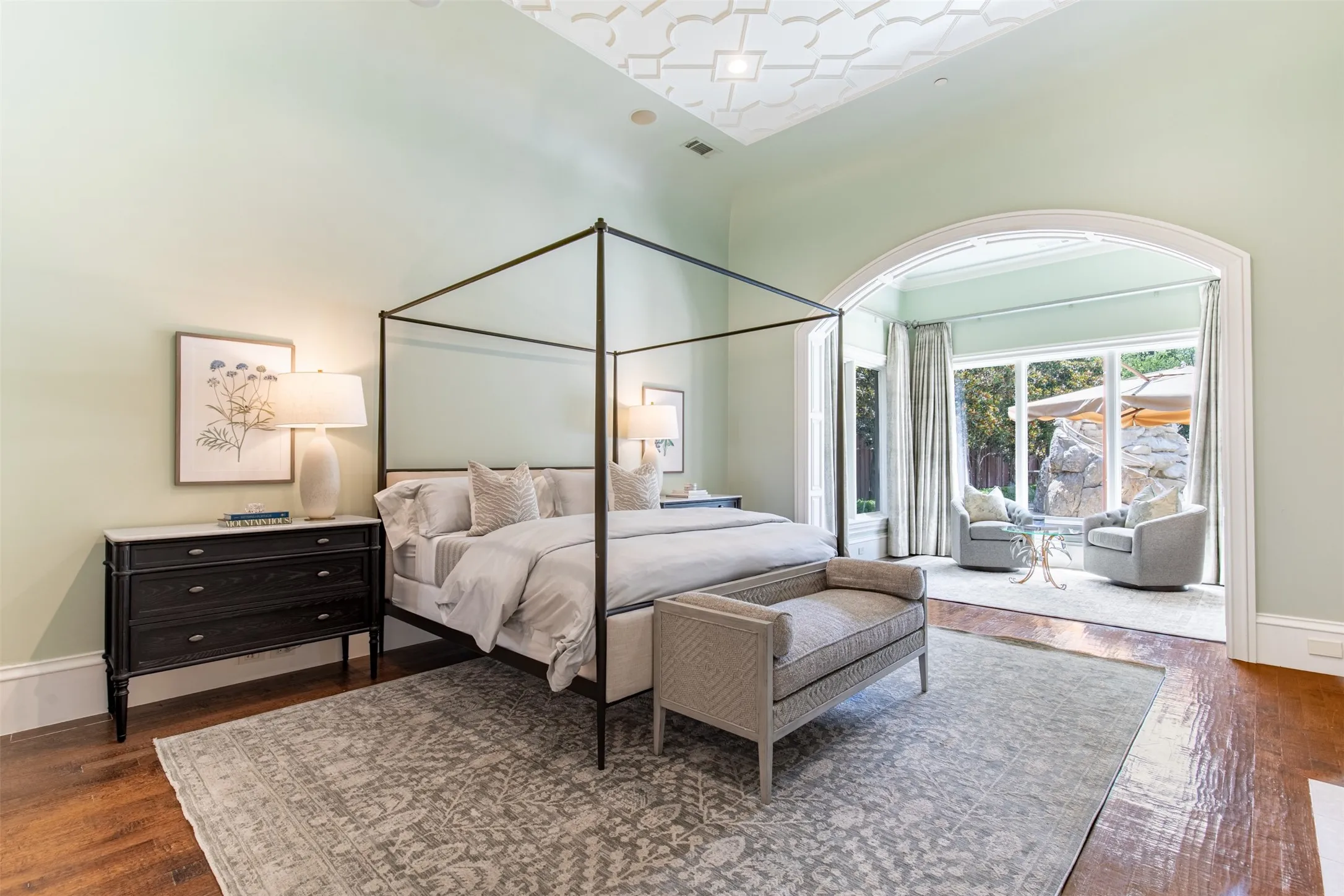 Spacious primary suite includes coffee bar area and separate exercise room. Primary bedroom has curved ceiling with decorative ceiling treatment, gas log fireplace and sitting room.