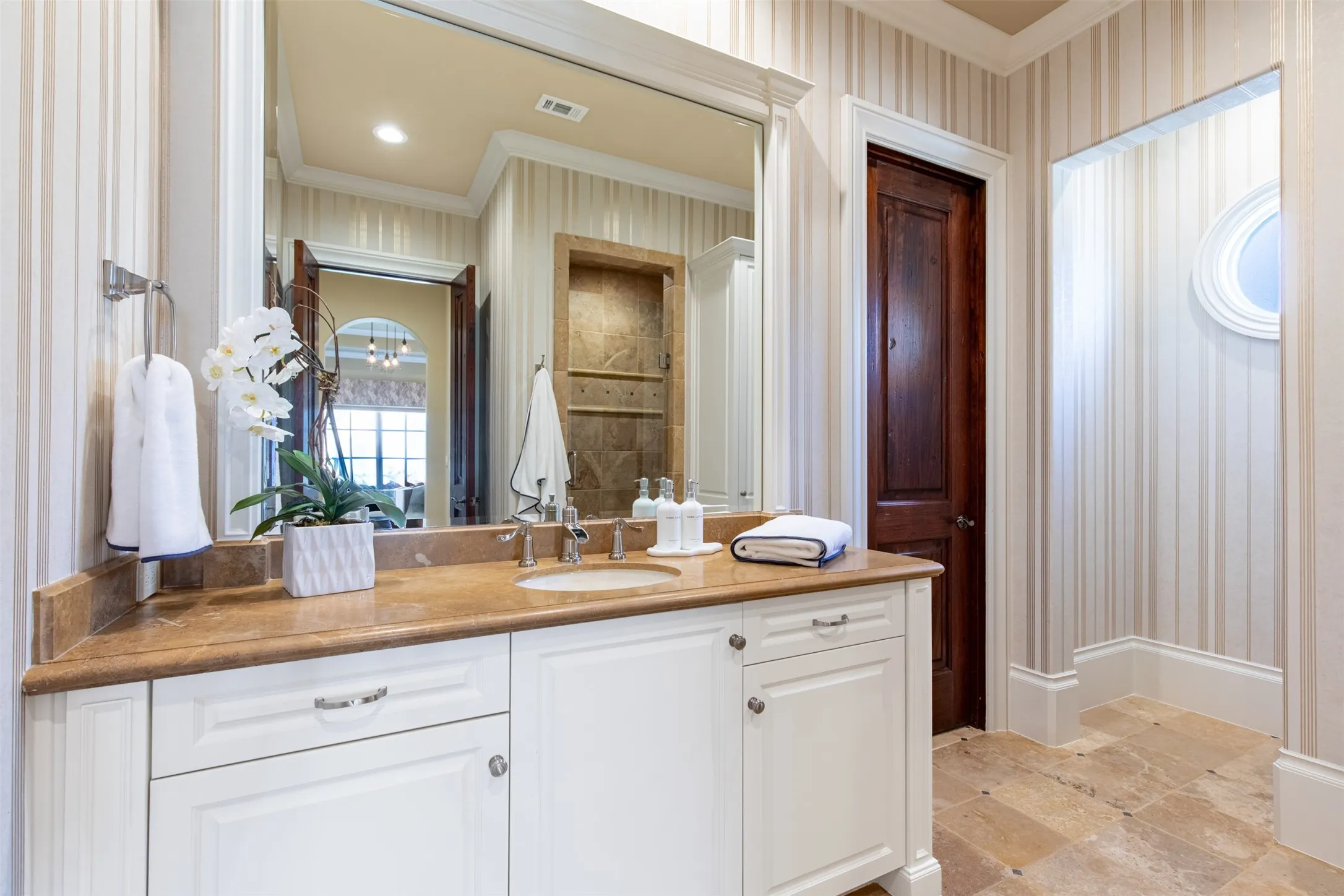 Spacious upstairs secondary bathroom featuring a single vanity with a warm-toned countertop, a rectangular undermount sink, and polished chrome fixtures