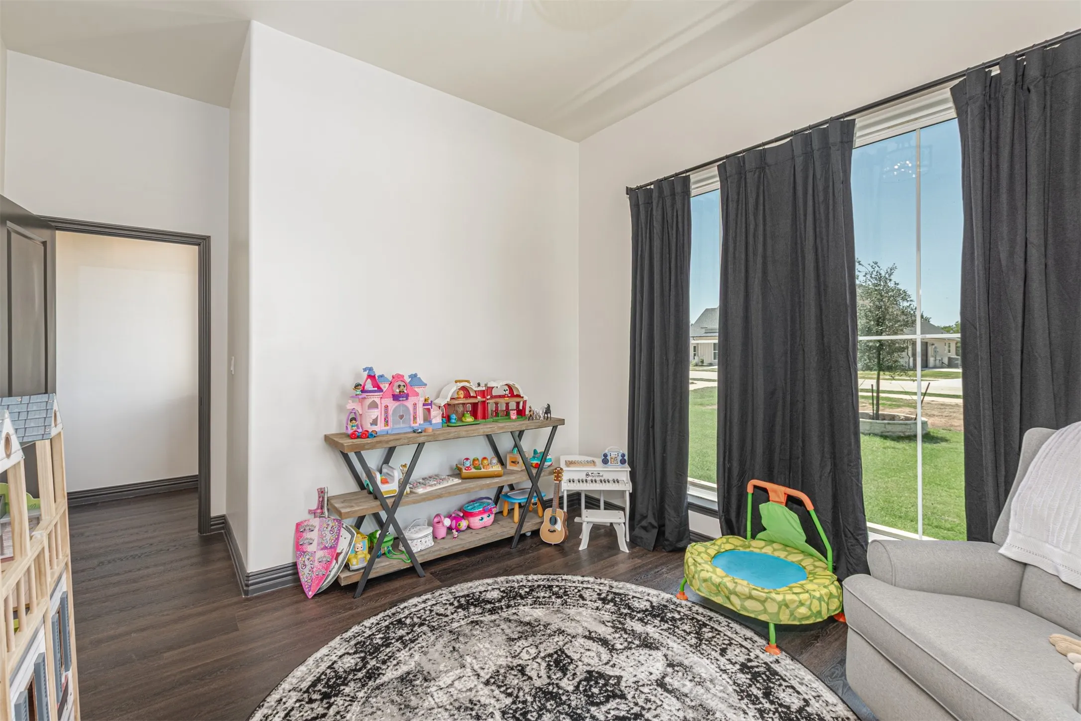 Bright interior space featuring wood-finish flooring, white walls, and crown molding