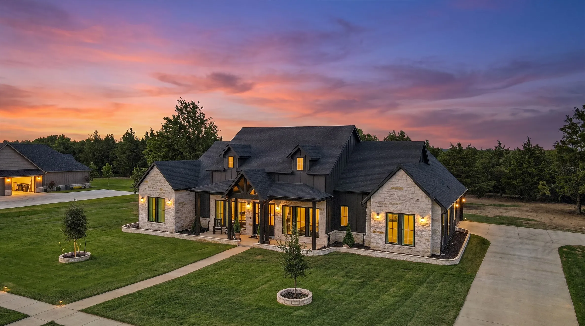 Stone and board-and-batten siding exterior with a dark shingle roof