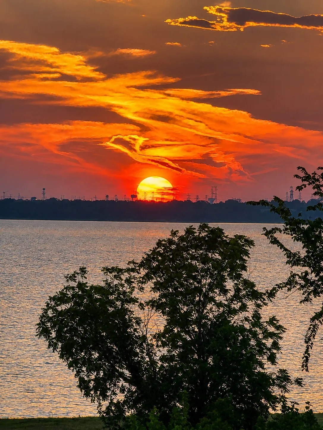 Spectacular sunset views over the lake, enjoyed from multiple levels of the home and its expansive balconies.