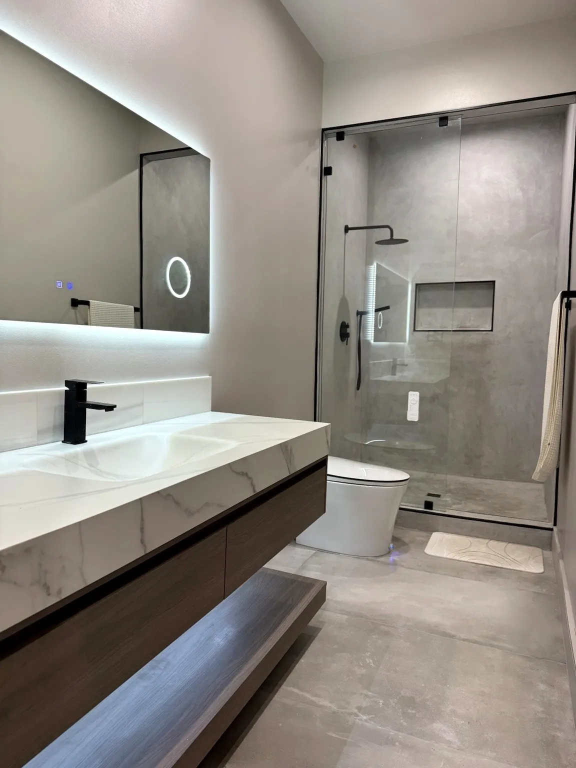Secondary full bath featuring glass-enclosed walk-in shower, modern designer fixtures, contemporary tile, and bidet.