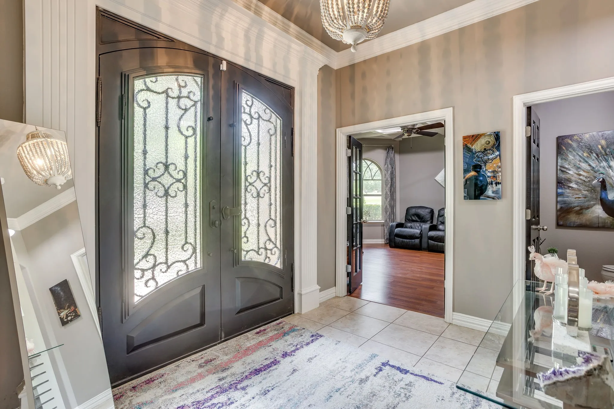 Grand entry with double doors featuring decorative ironwork and frosted glass
