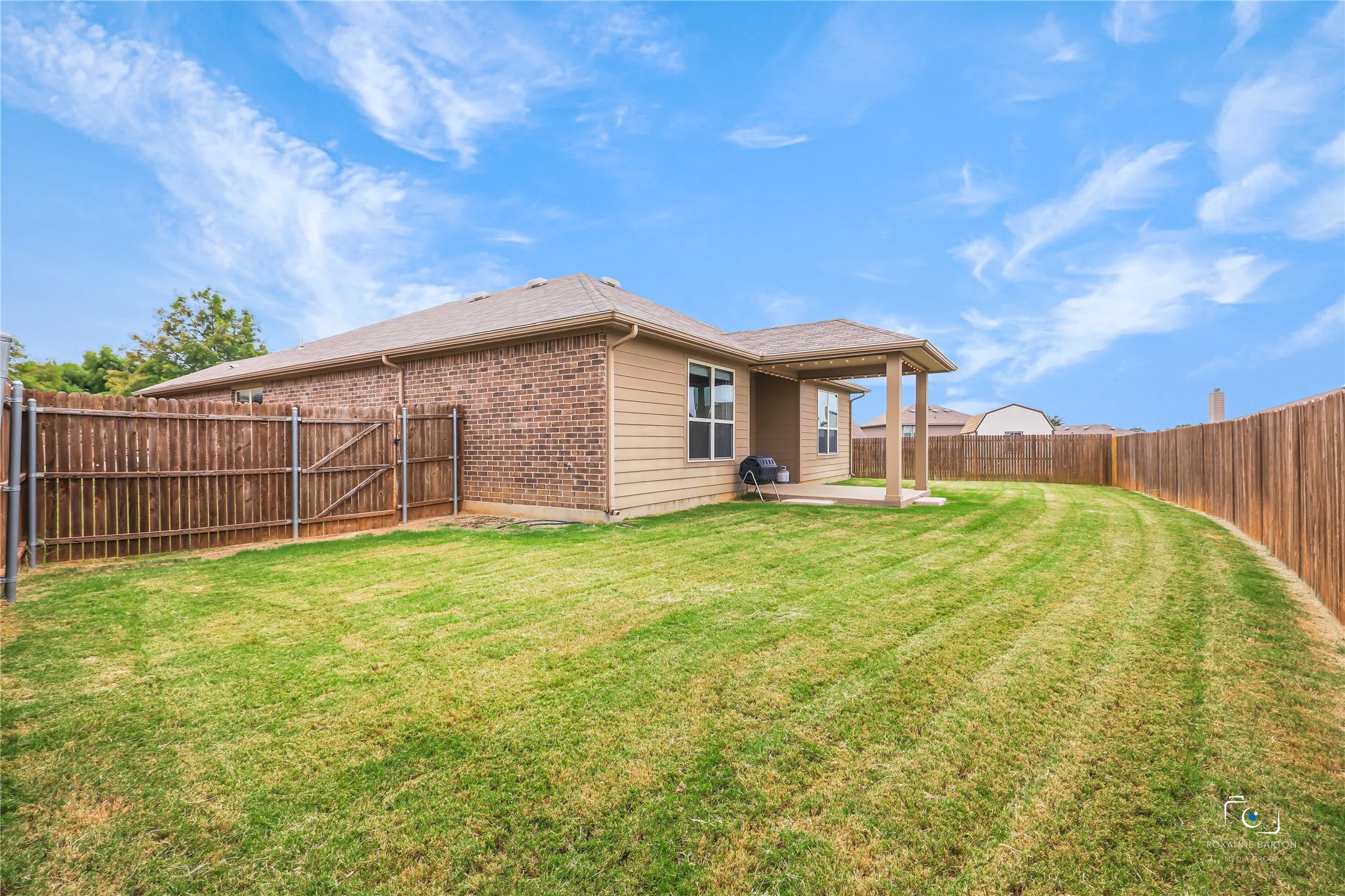 This large over sized back yard with wood fence and plenty of space for a pool
