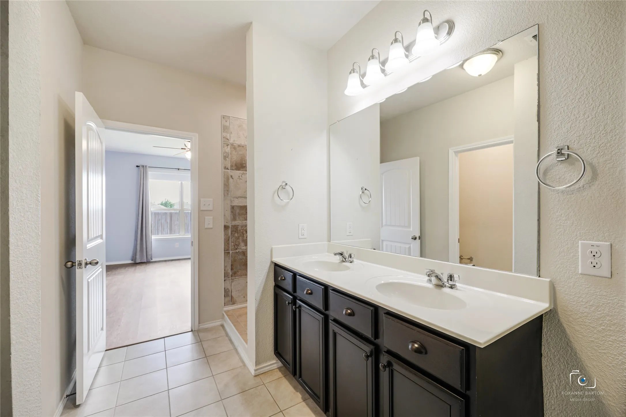 This ensuite bath also has a tiled space. Use your imagination for a make-up desk or possible shelving for linens. The possibilities are endless