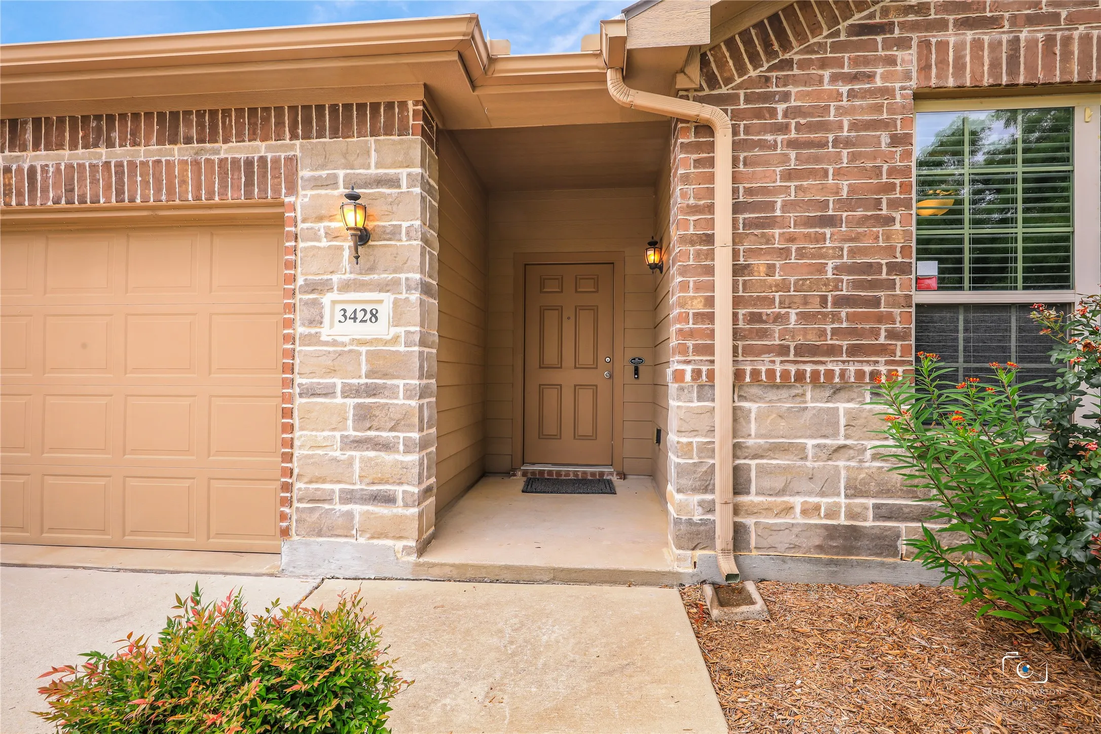 Covered front porch and landscaped flowerbed