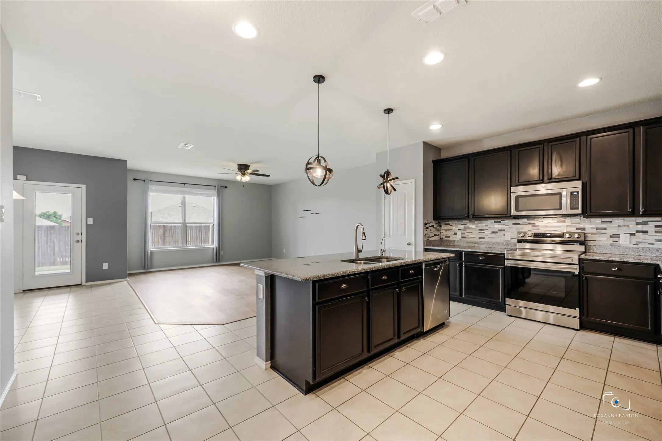 Open floorplan with Kitchen looking on to large living area with Luxury vinyl flooring.