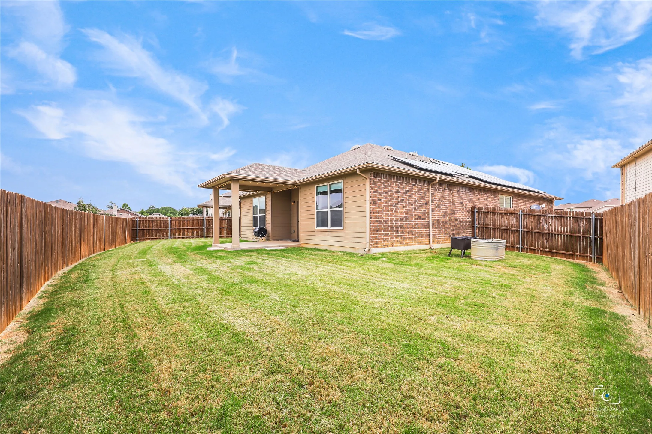Oversized private back yard with above the ground garden features and a large covered patio.