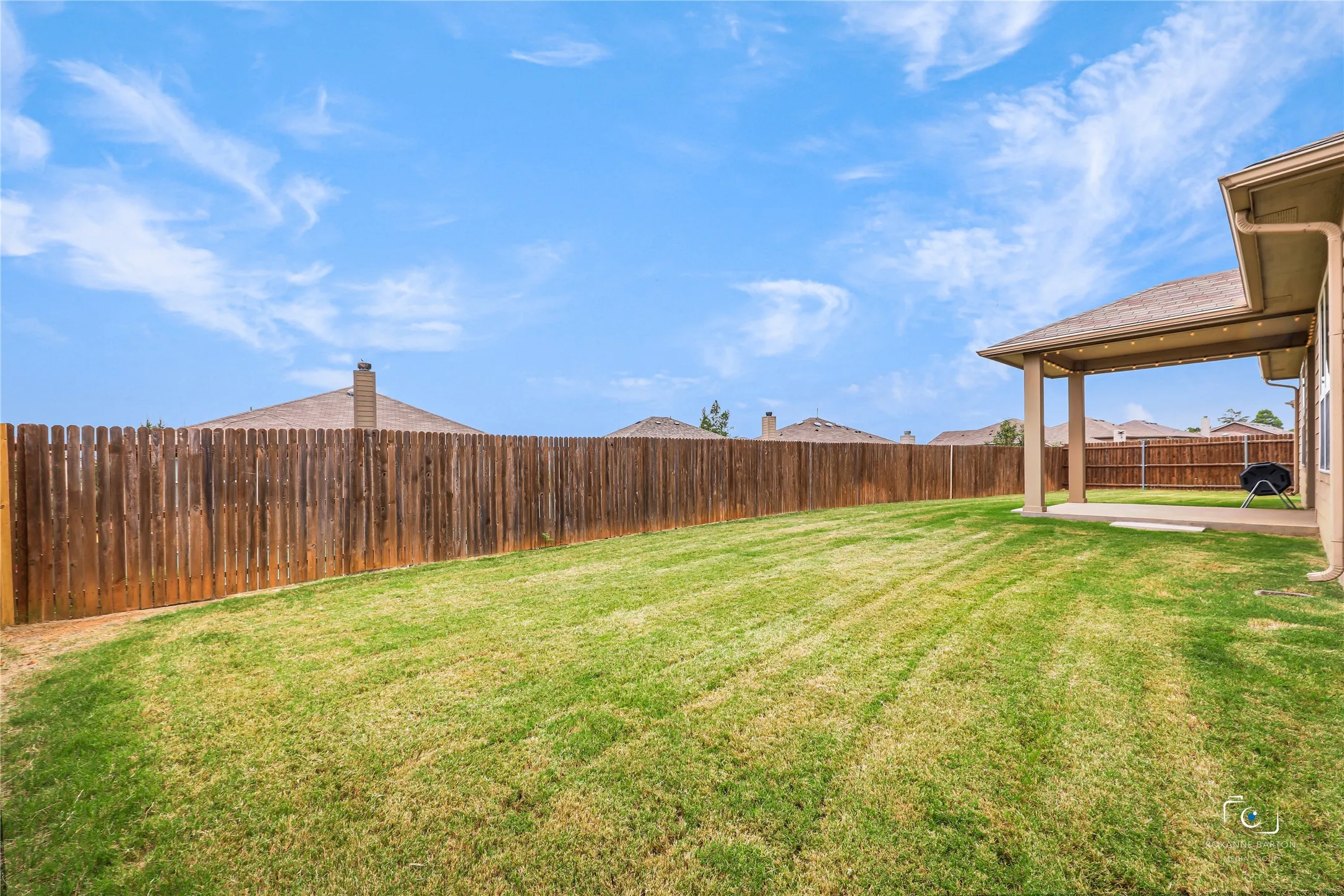Another view of the private oversized back yard with sprinkler system.