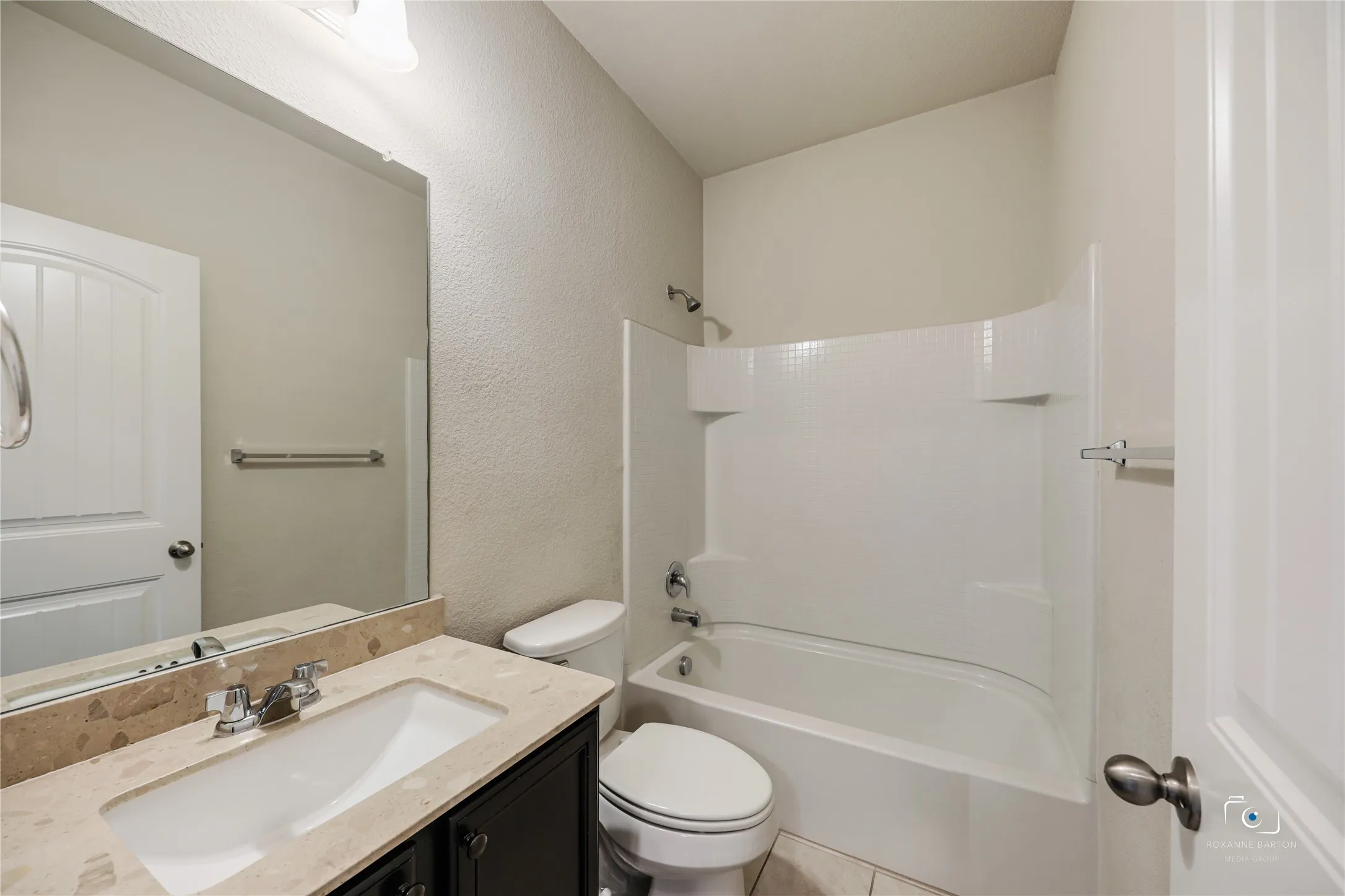 Secondary bathroom with linen closet just outside.