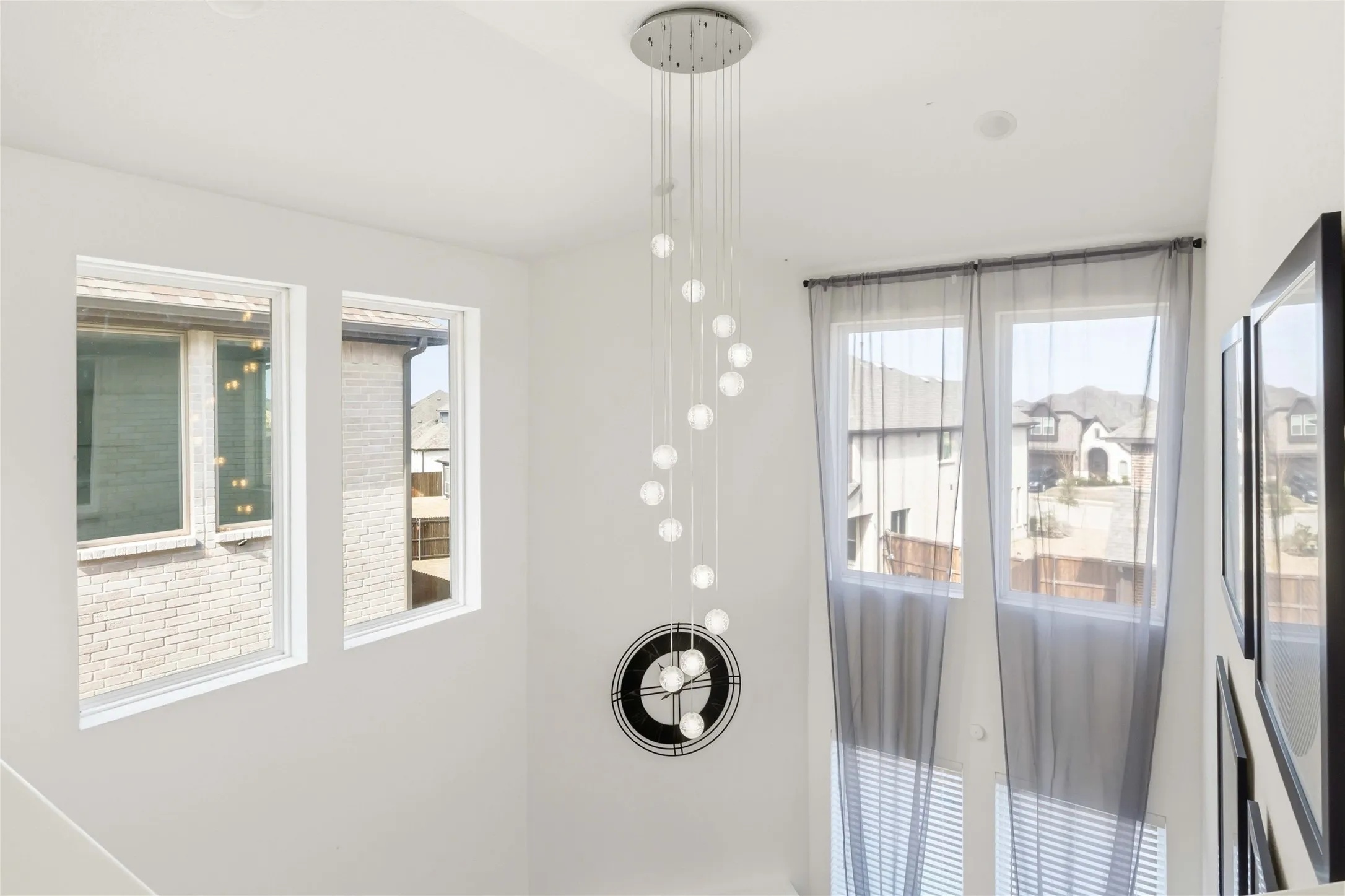 Contemporary multi-globe pendant light fixture with a polished chrome ceiling plate