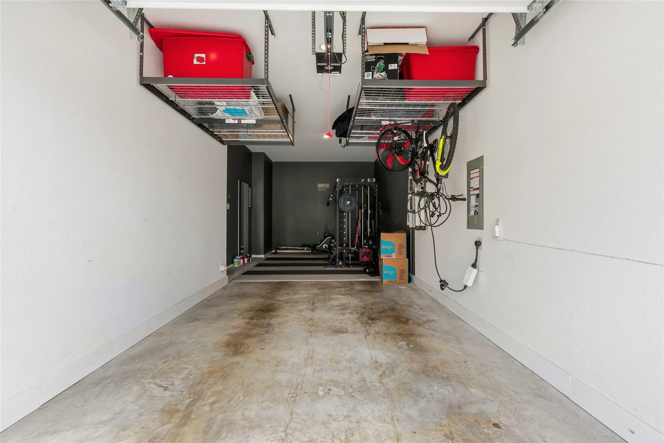 Garage interior with concrete flooring and white painted walls
