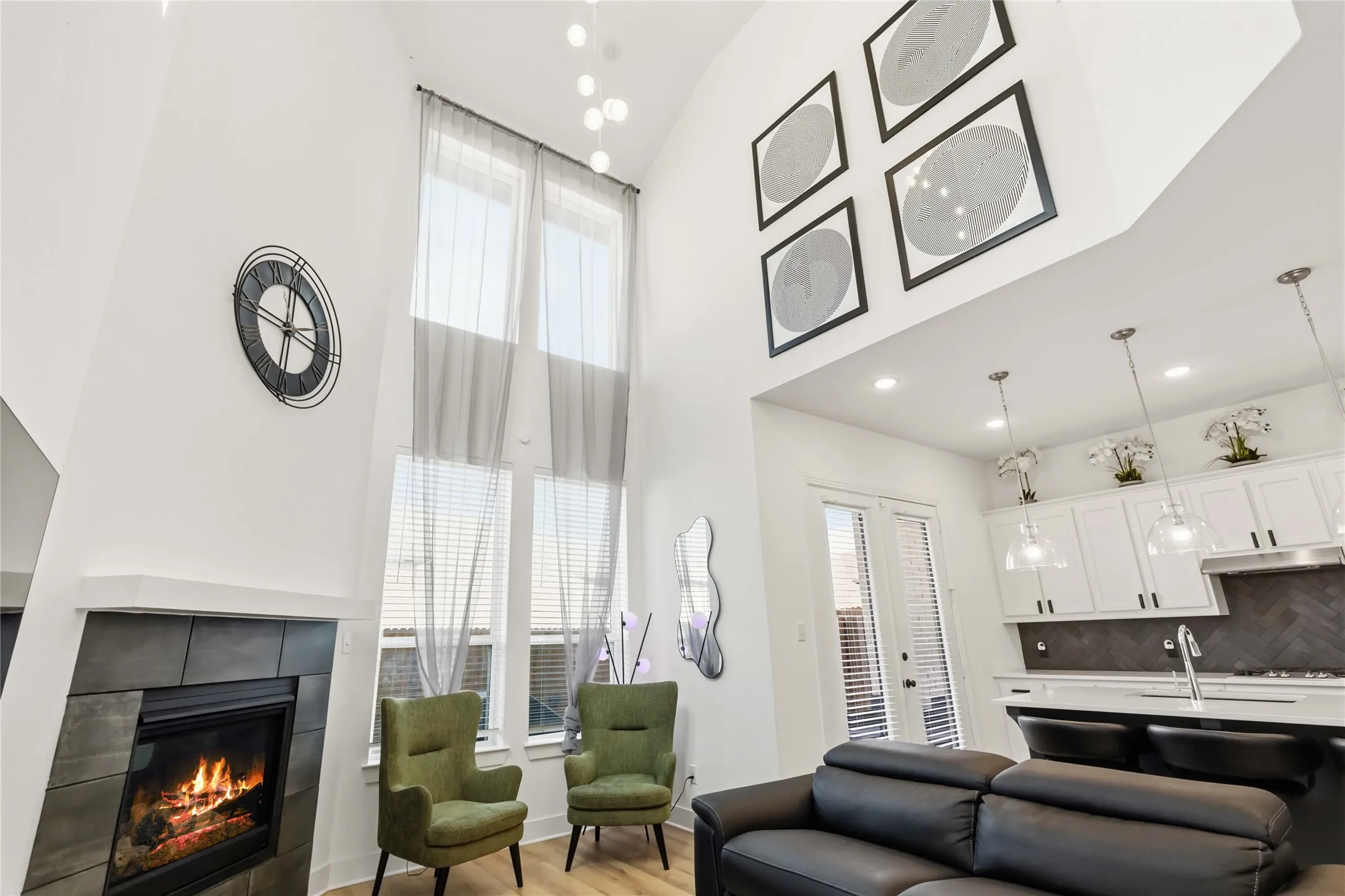 Vaulted ceilings define this open-concept living space, featuring a fireplace with a dark tile surround