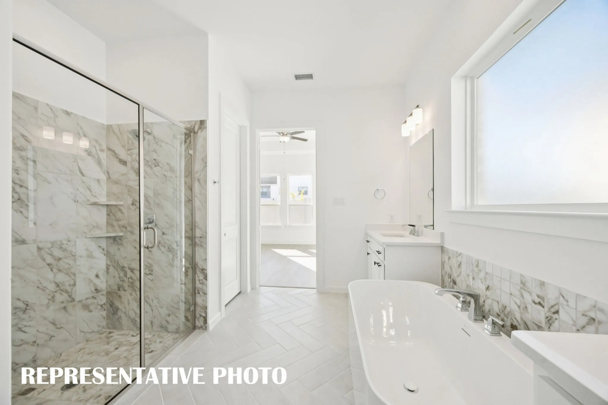 This fantastic owner's bath offers a spacious walk in shower and a wonderful garden tub perfect for soaking your cares away!  REPRESENTATIVE PHOTO