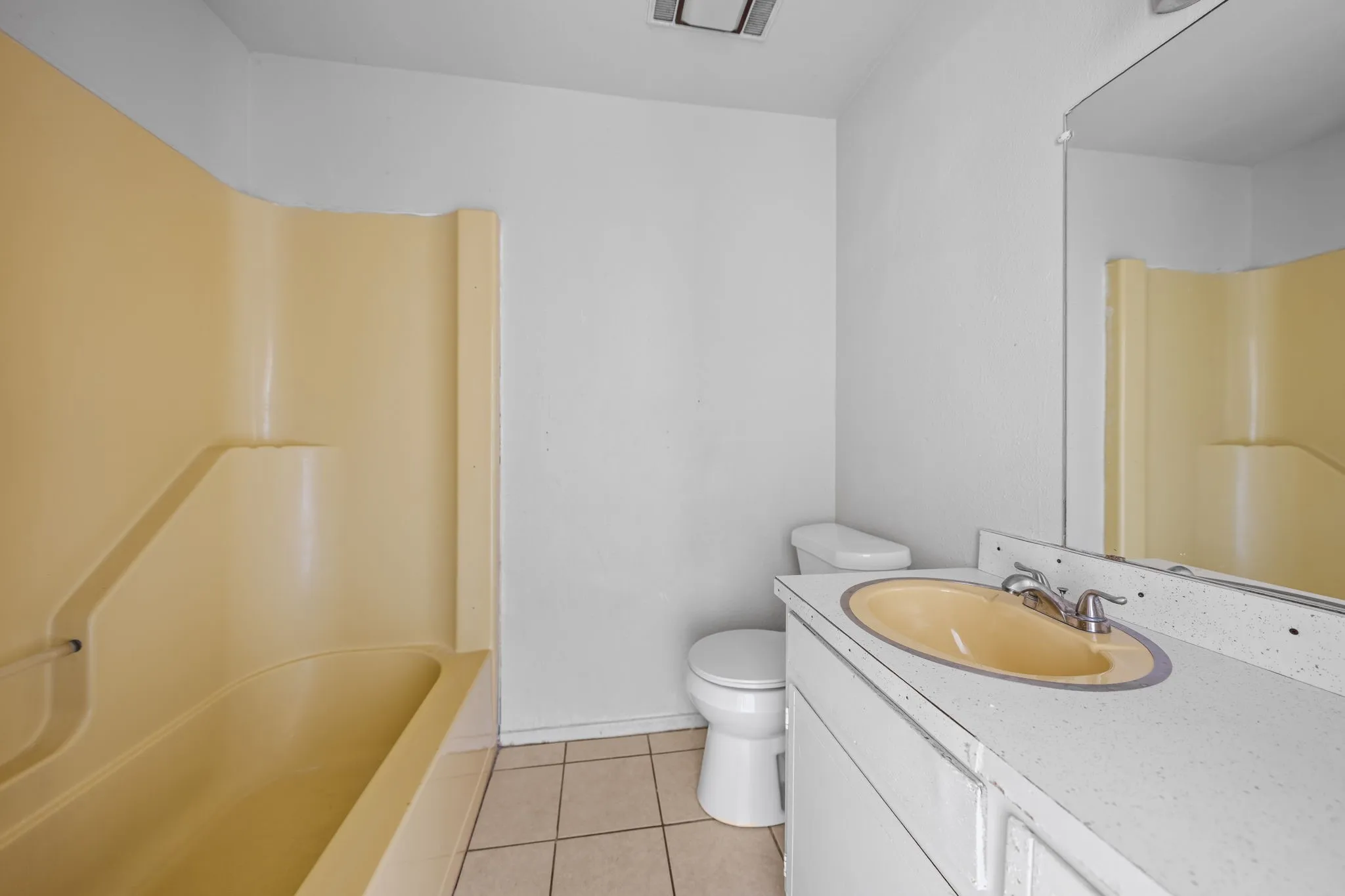 Full bath featuring vanity and light tile patterned flooring