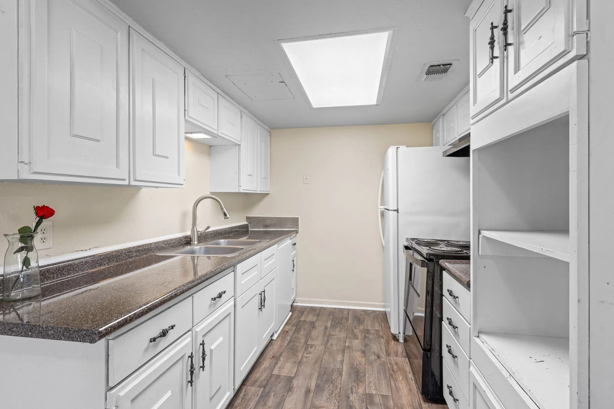 Kitchen with white cabinetry, black range with electric cooktop, dark wood-style flooring, and open shelves
