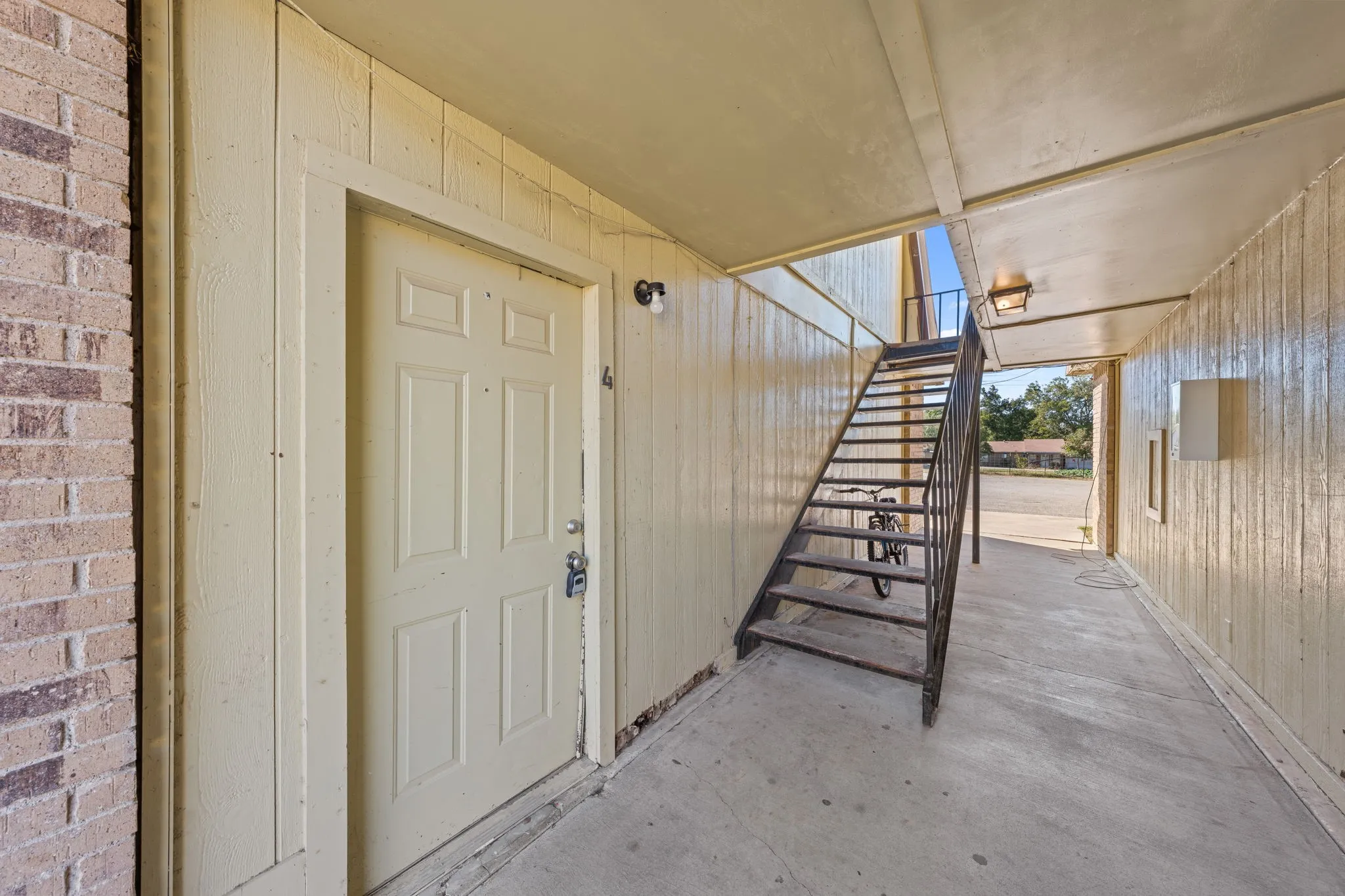 Entrance to property with a patio area and brick siding