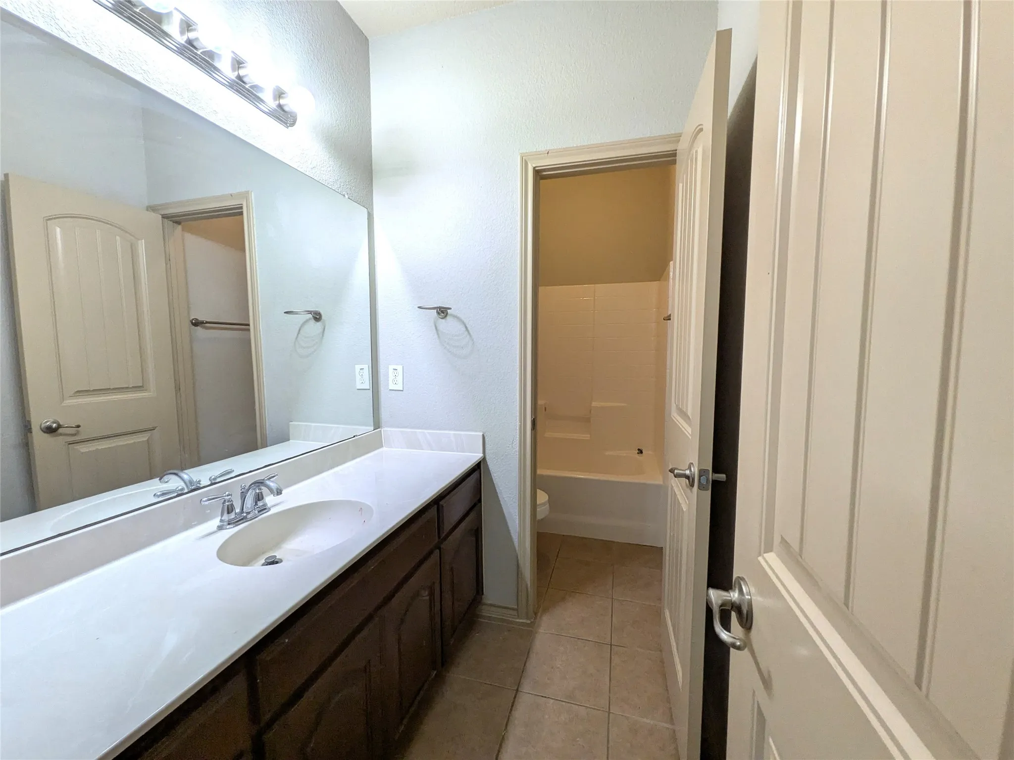 Bathroom vanity with a white countertop and an integrated sink
