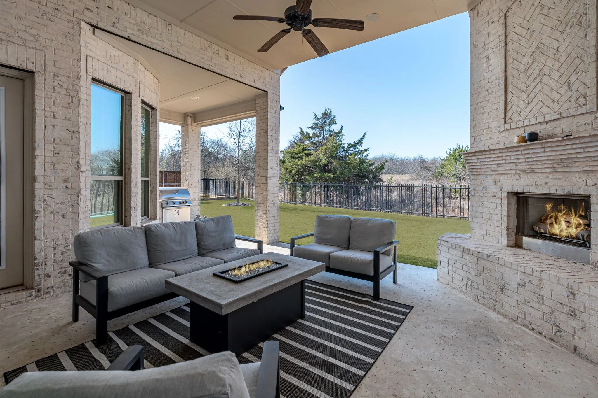 Large Covered Back Porch With Huge Fireplace And Built-In Grill.