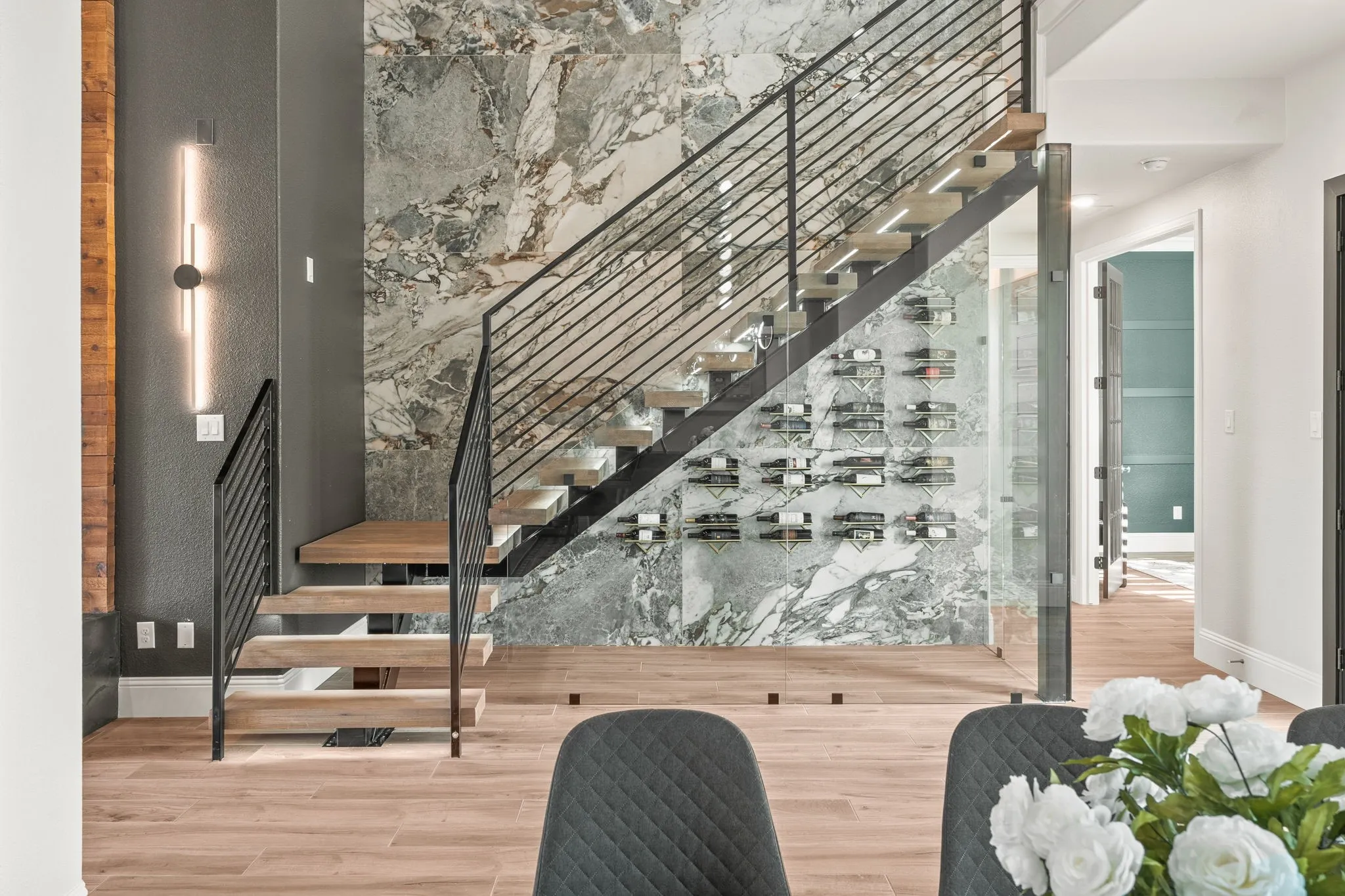 Stunning Light-Filled Staircase (Open-Riser) With Marble Accented Wall.