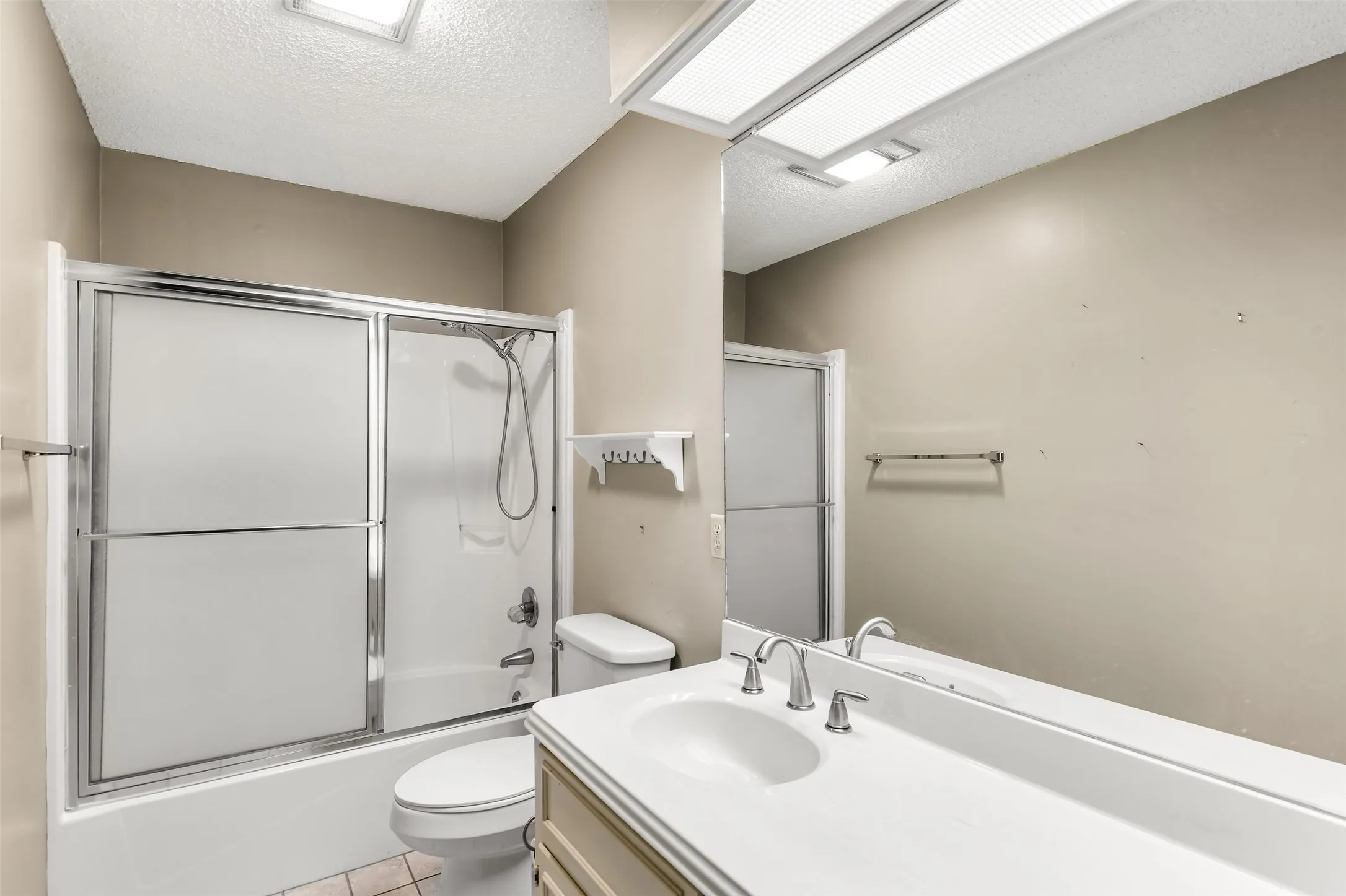 Integrated vanity with single basin sink and polished chrome faucet