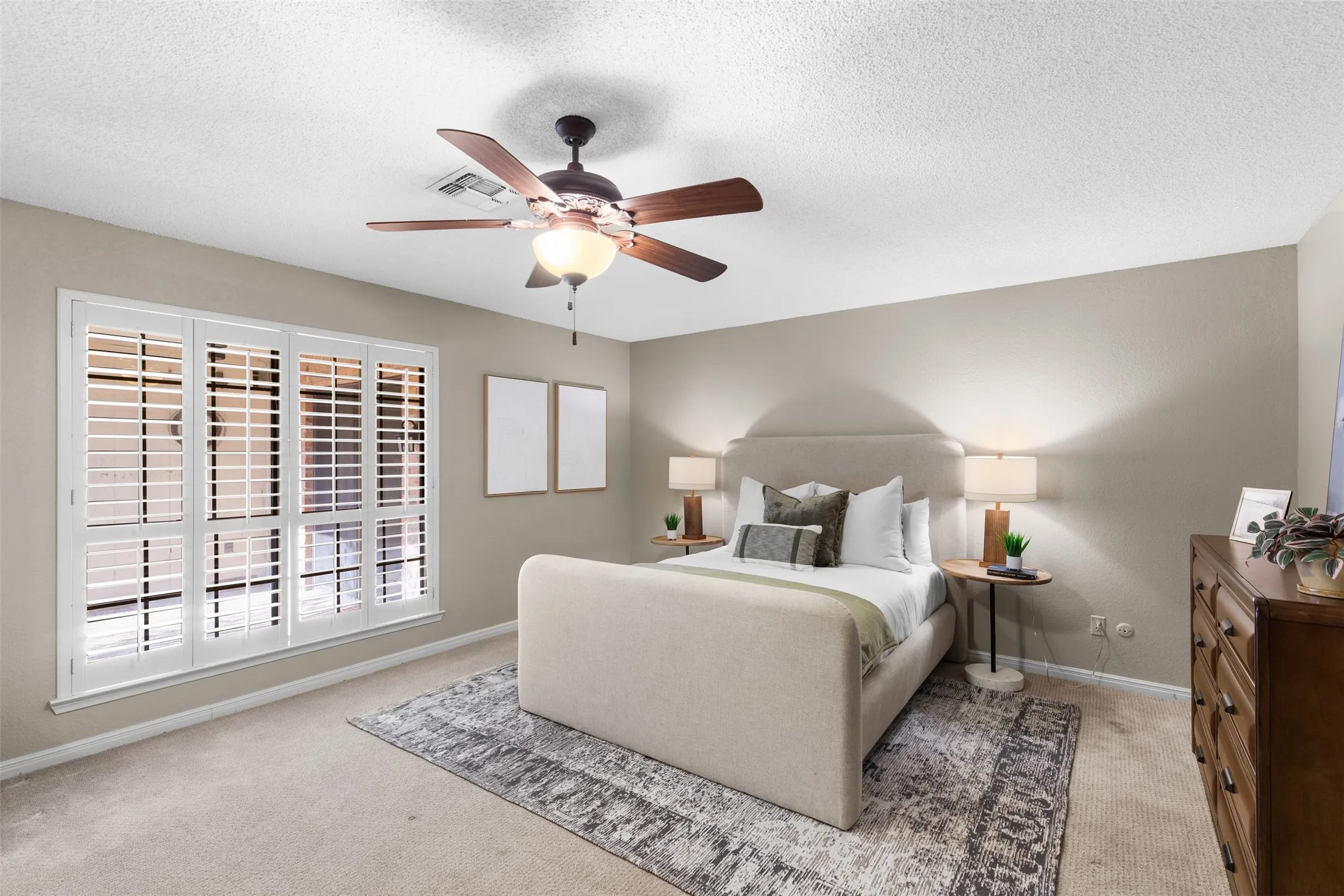 Window featuring white plantation shutters and a ceiling fan with integrated lighting