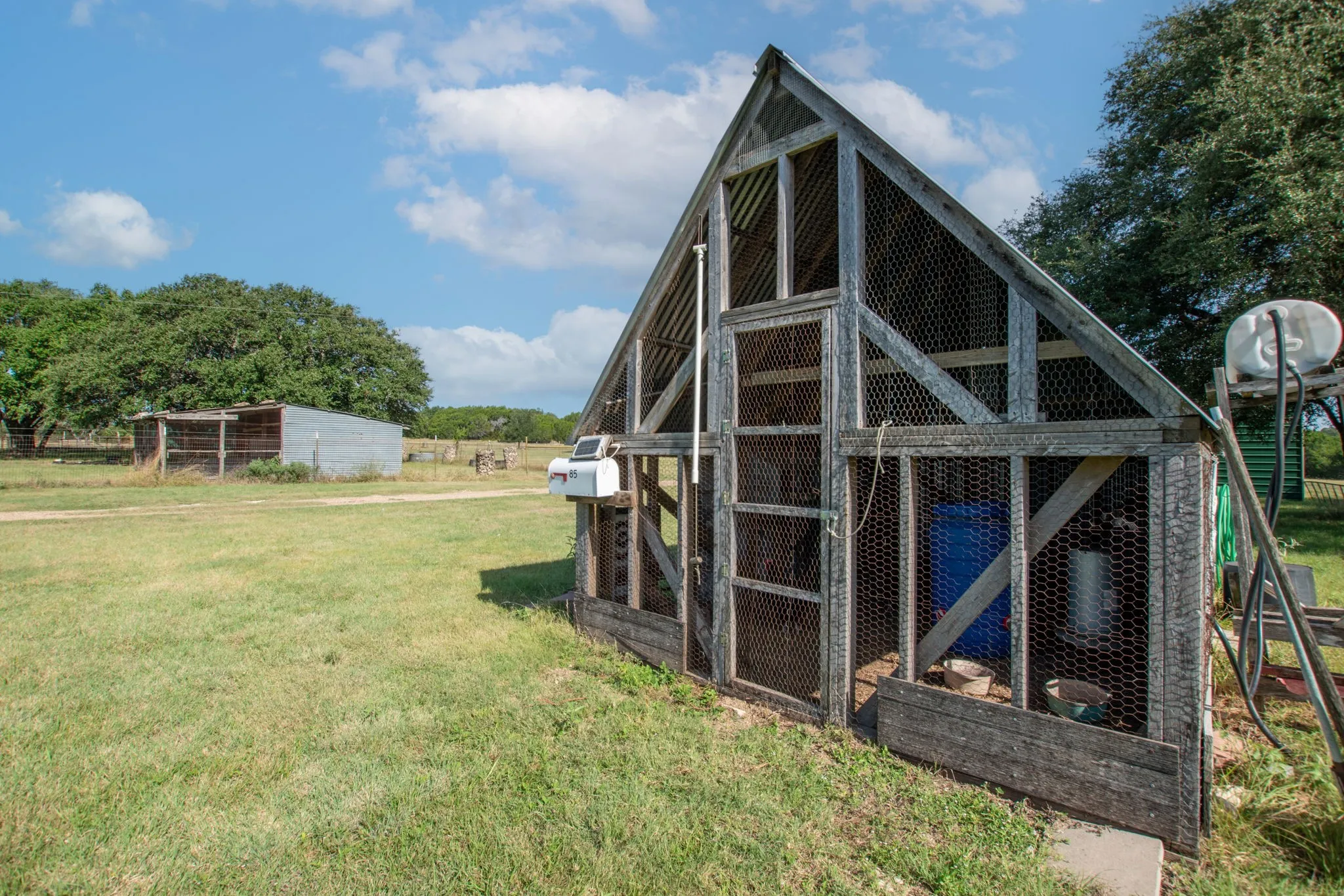 Wooden-frame enclosure with wire mesh siding