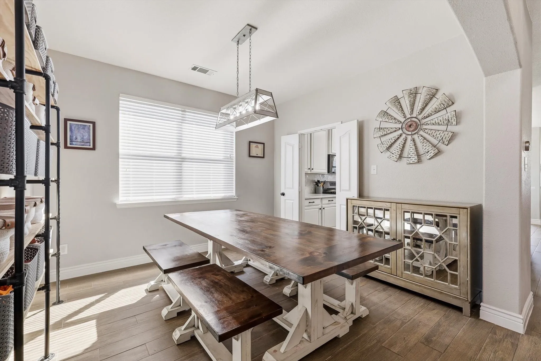 Dining area featuring wood-finish flooring and a rectangular window with blinds