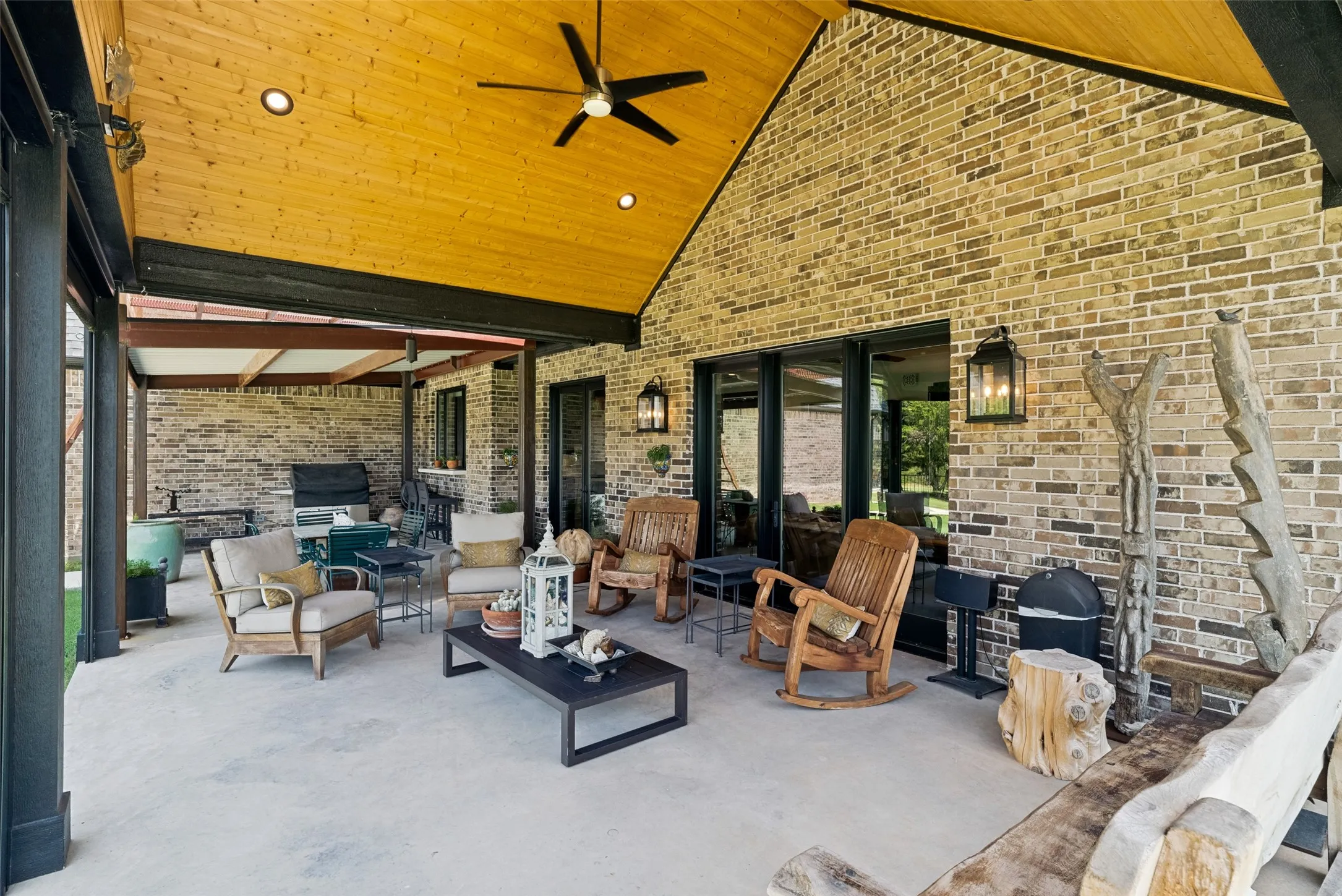 Huge covered patio with wood ceiling & ceiling fan