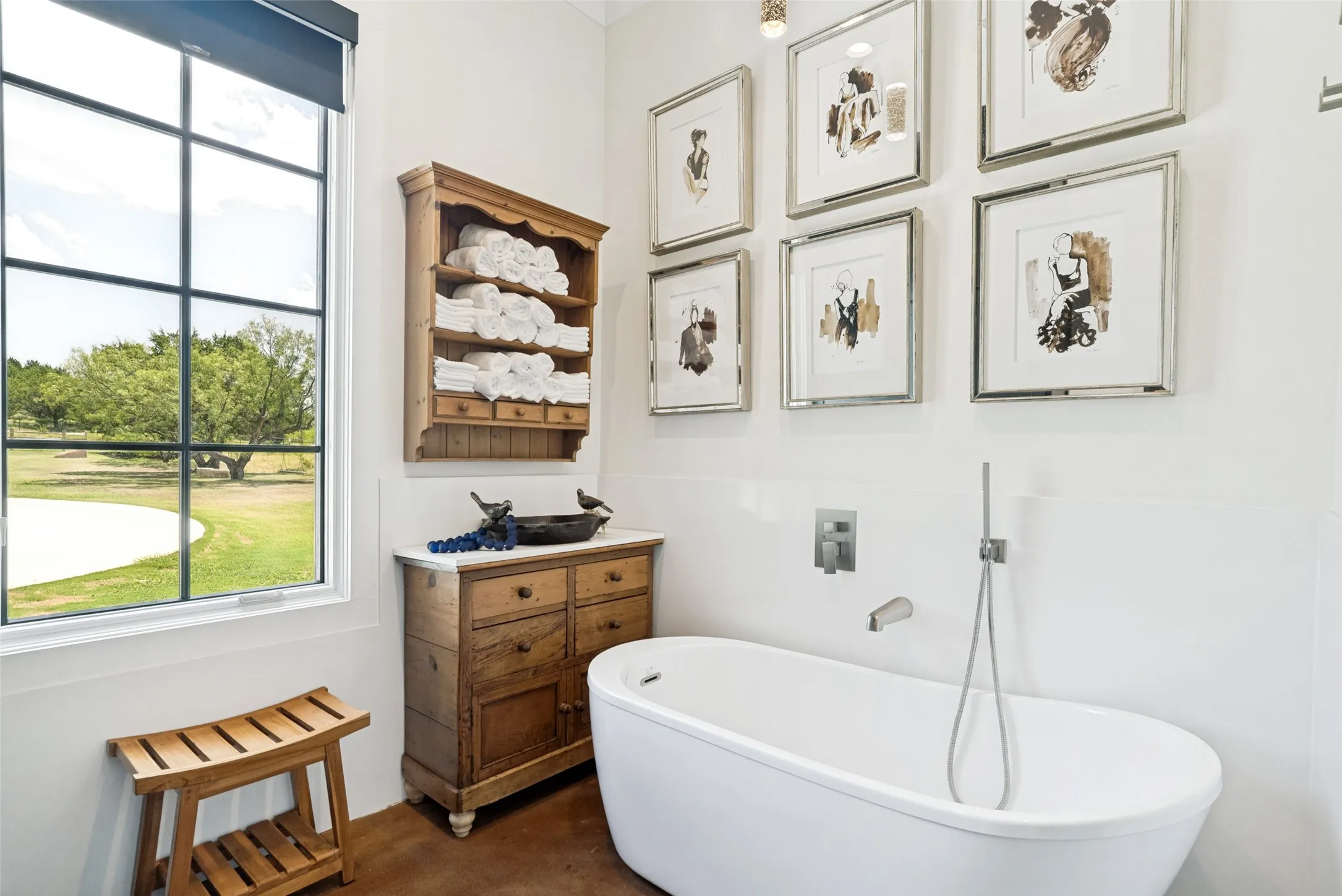 Beautiful soaking tub with shower wand and toilet, separate from vanity.