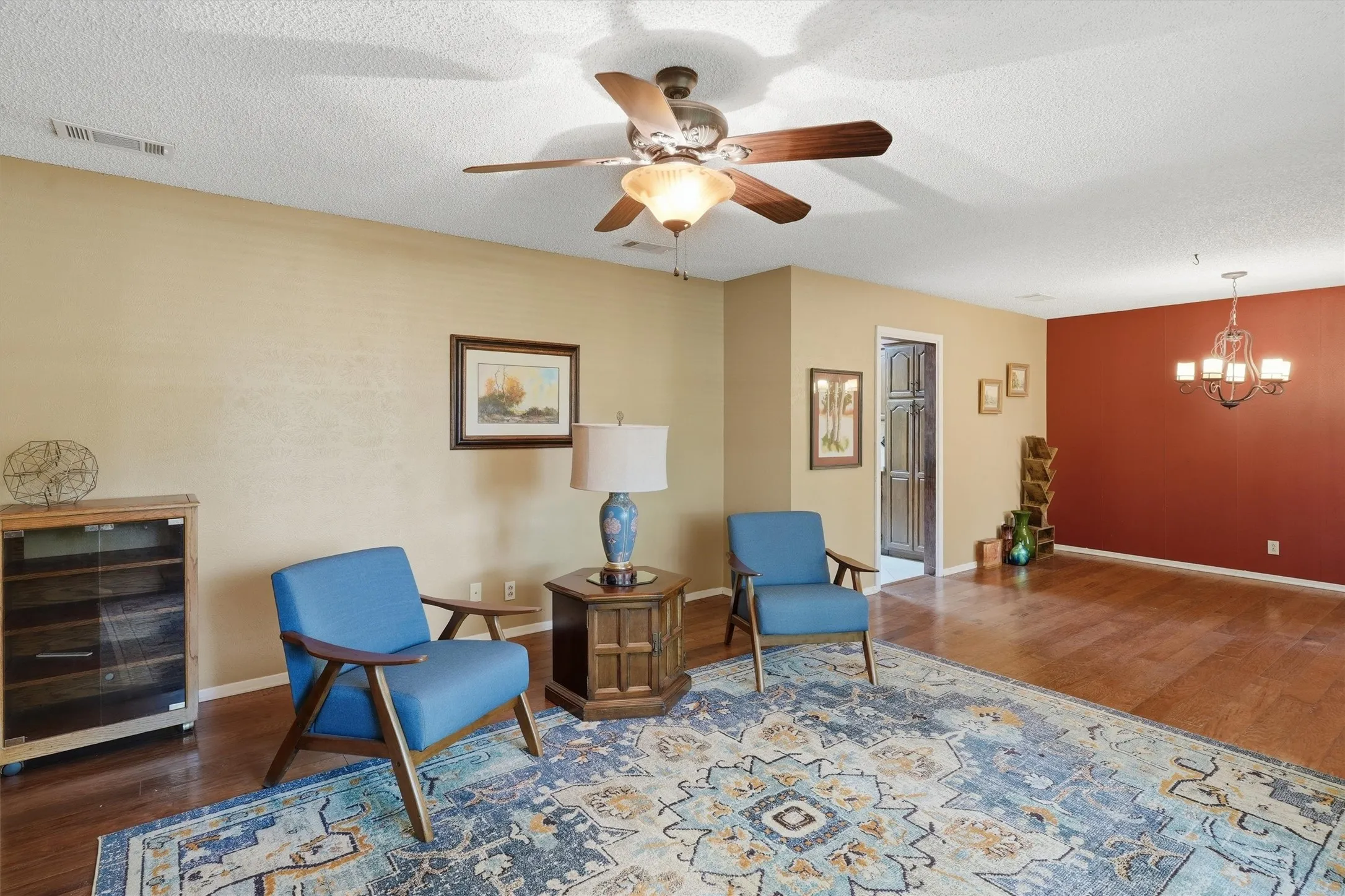 Hardwood flooring throughout featuring a ceiling fan with integrated lighting